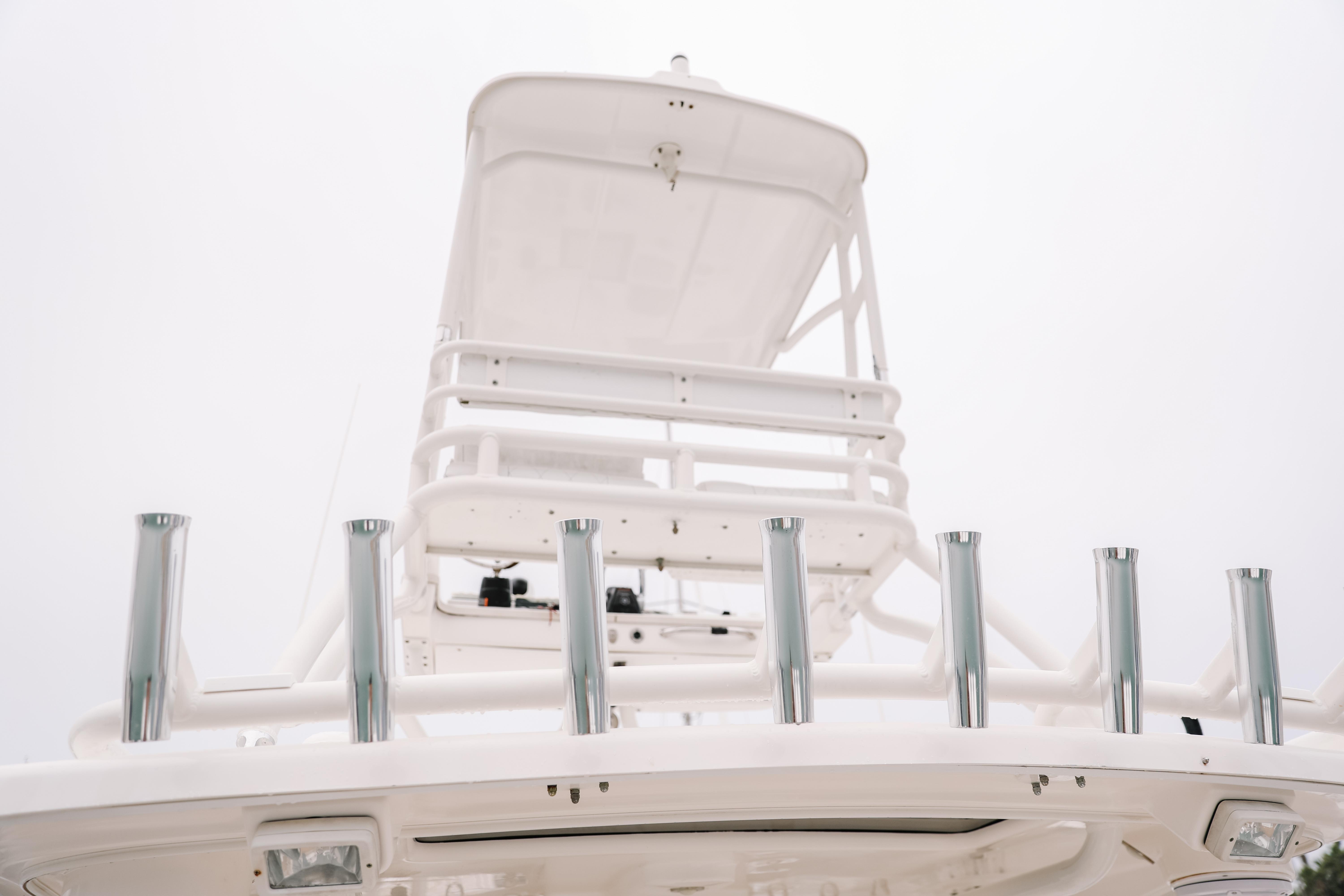 2010 Everglades 350LX boat tower with rod holders against a cloudy sky.
