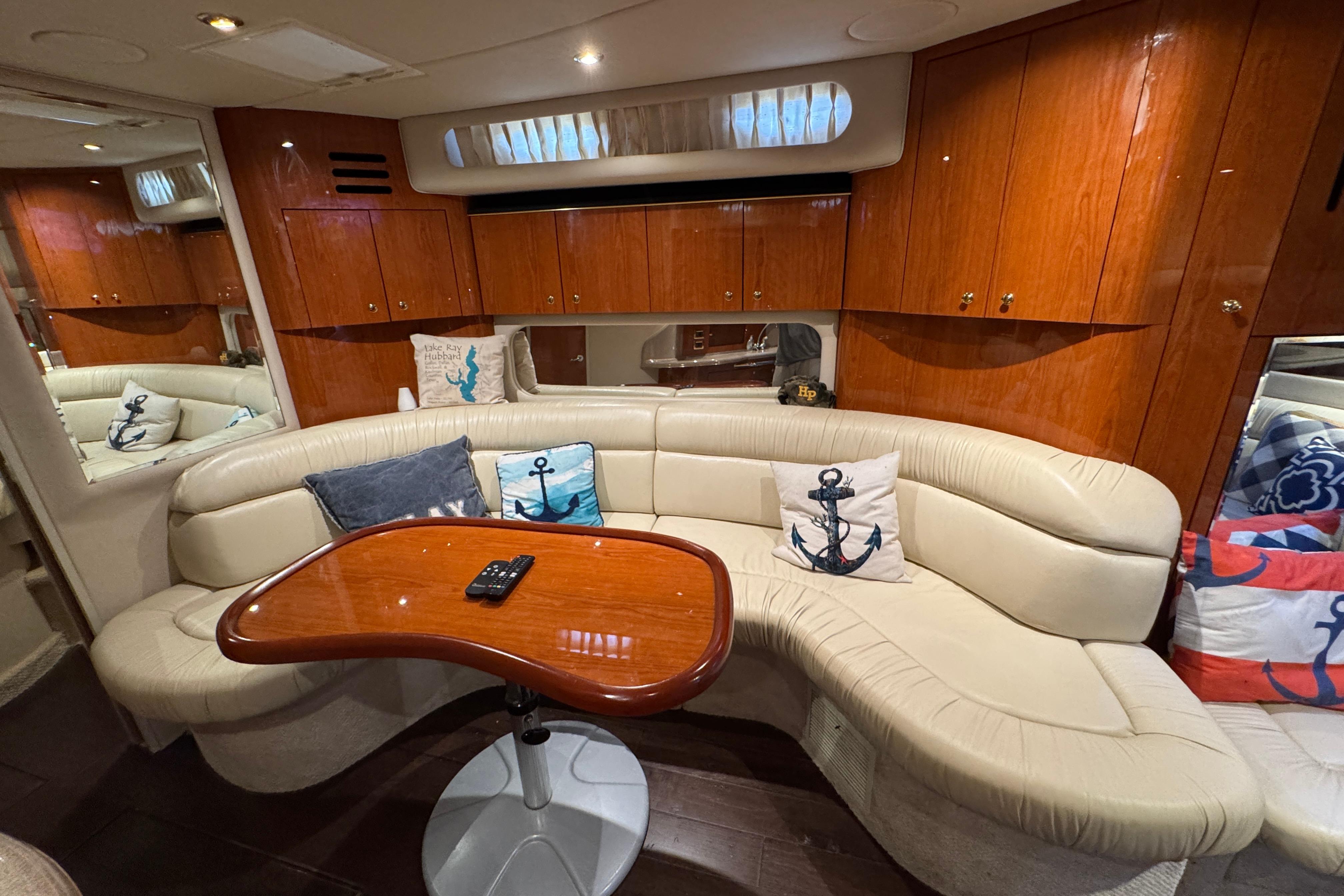Luxurious interior of 2001 Sea Ray 380 Sundancer with plush seating and nautical decor.