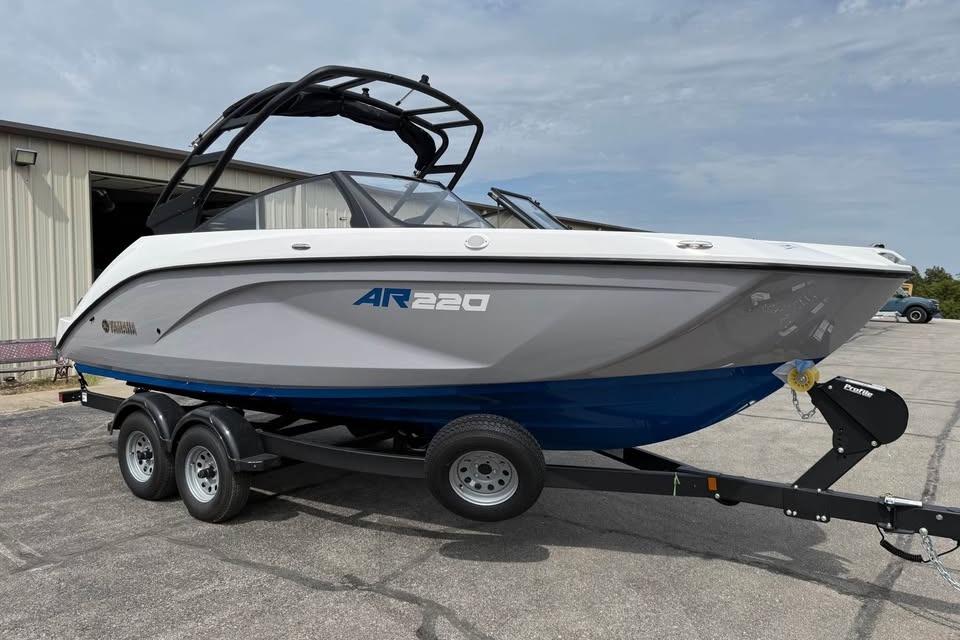 2026 Yamaha Boats AR220 on trailer, parked outside a building.