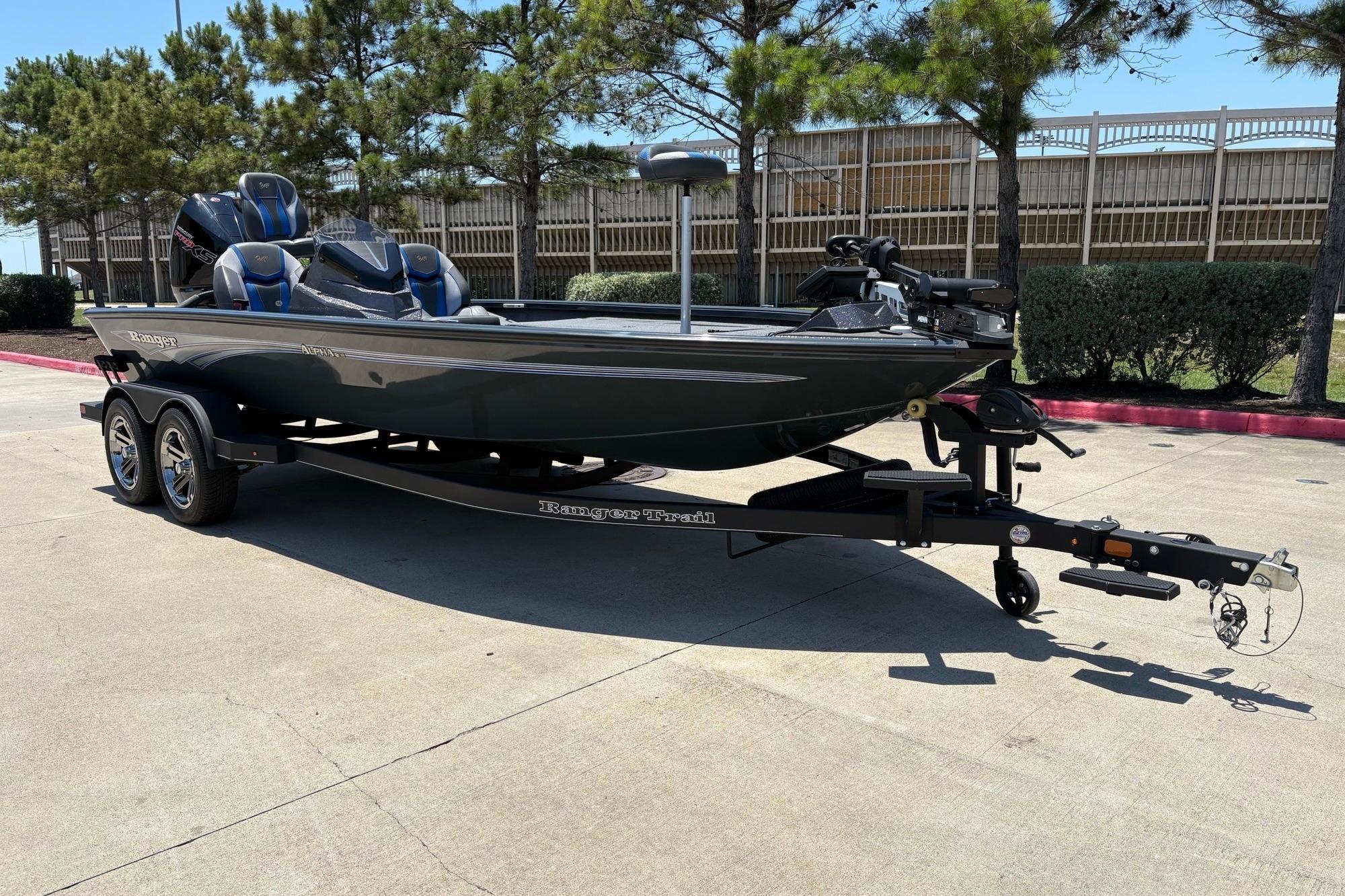 2025 Ranger ALPHA 208 boat on trailer, parked outdoors, surrounded by trees.
