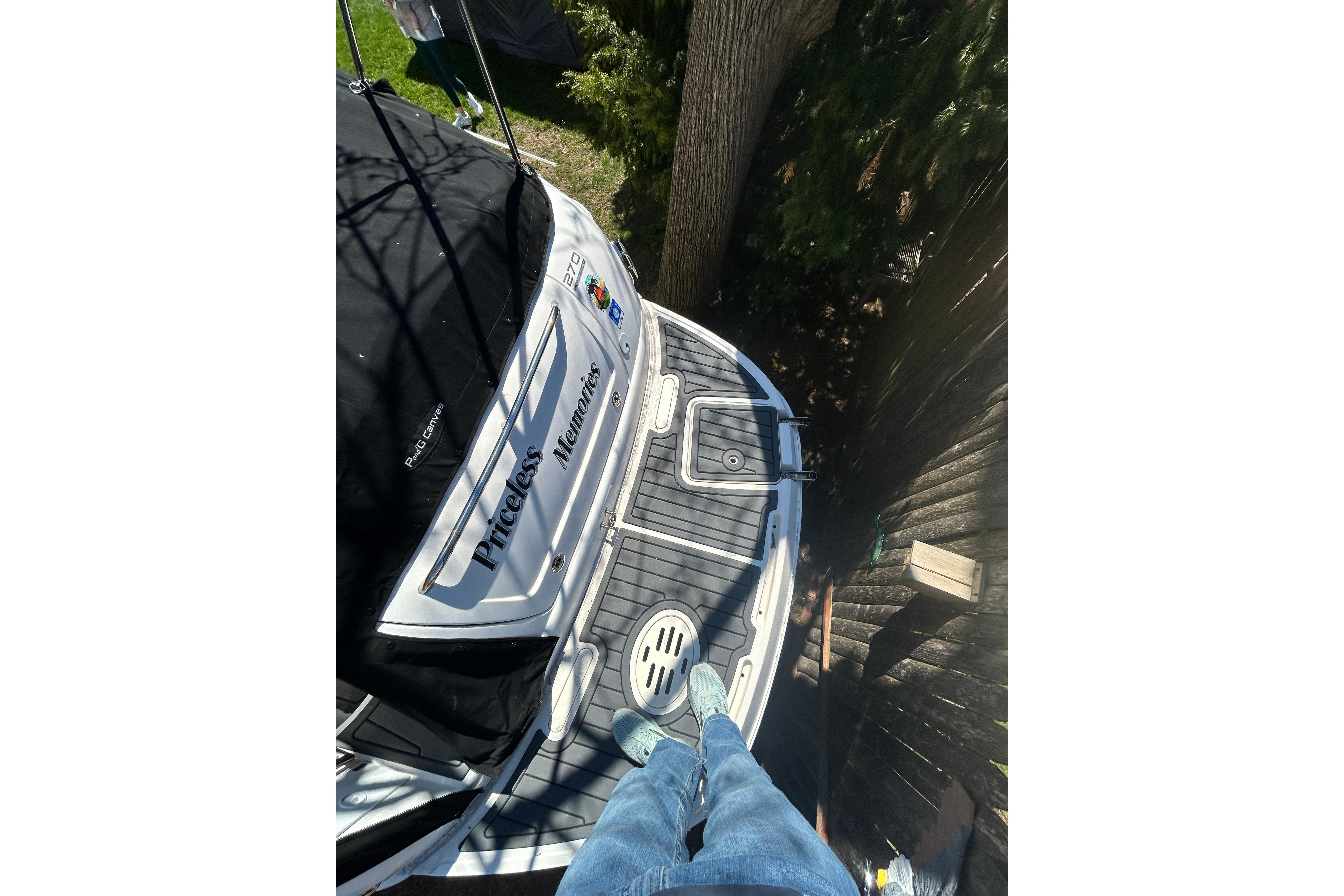 Person standing on 2006 Monterey 270 Cruiser boat deck, labeled "Priceless Memories."