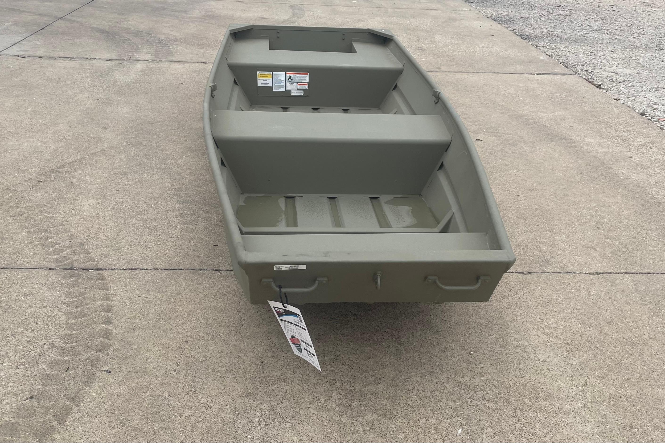2026 Tracker Grizzly 14 Jon boat on concrete surface, showcasing its sturdy design.