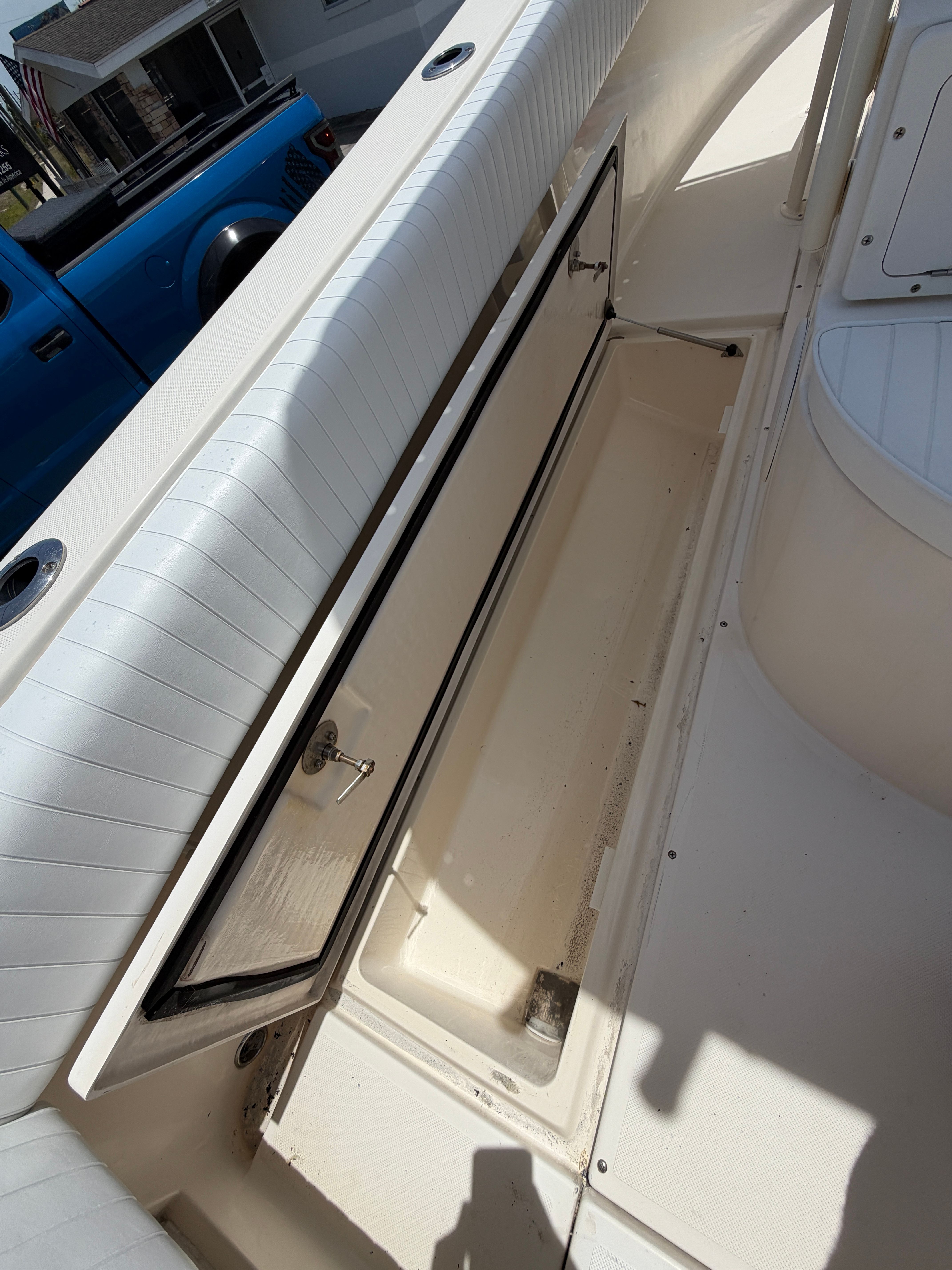 2004 McKee Craft 24 FREEDOM boat with open storage compartment.