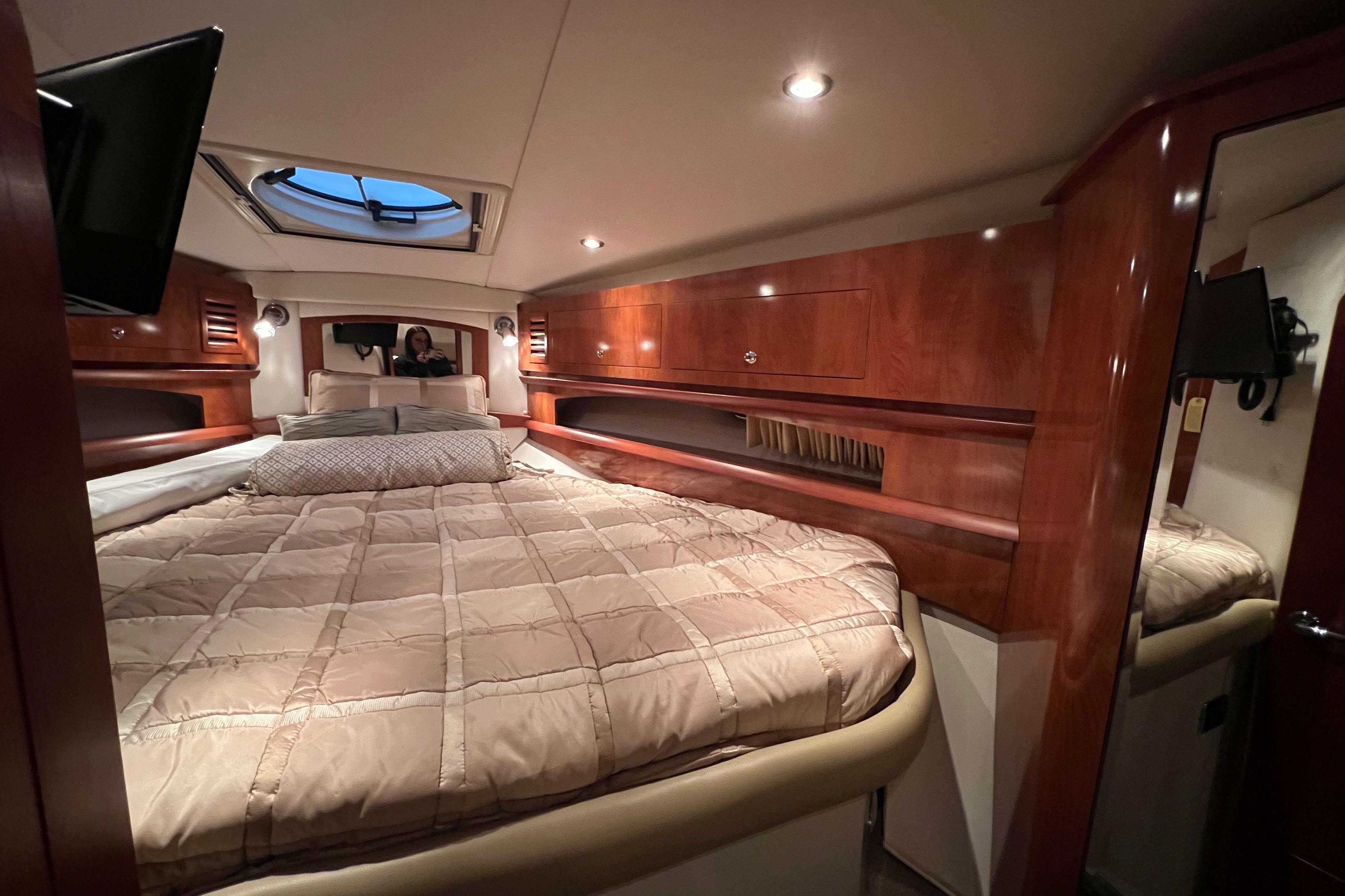 Luxurious cabin interior of 2008 Four Winns 378 Vista yacht with cozy bedding.