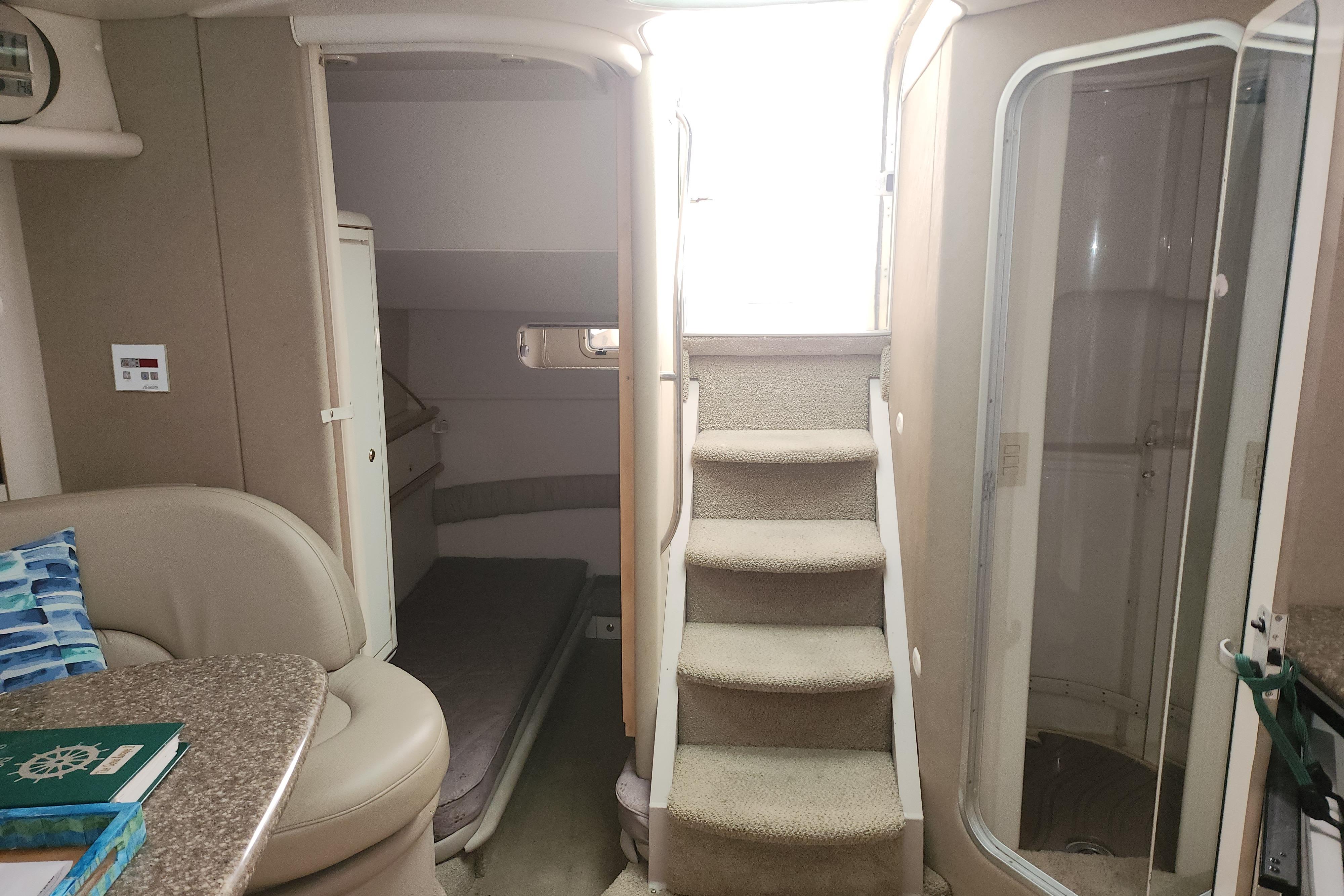 1999 Maxum 3700 SCR yacht interior with stairs, seating, and cabin area.