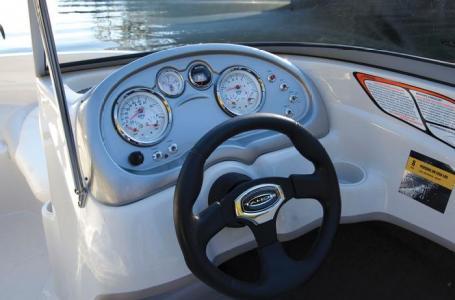 2012 Tahoe Q4 SS boat dashboard with steering wheel and gauges.