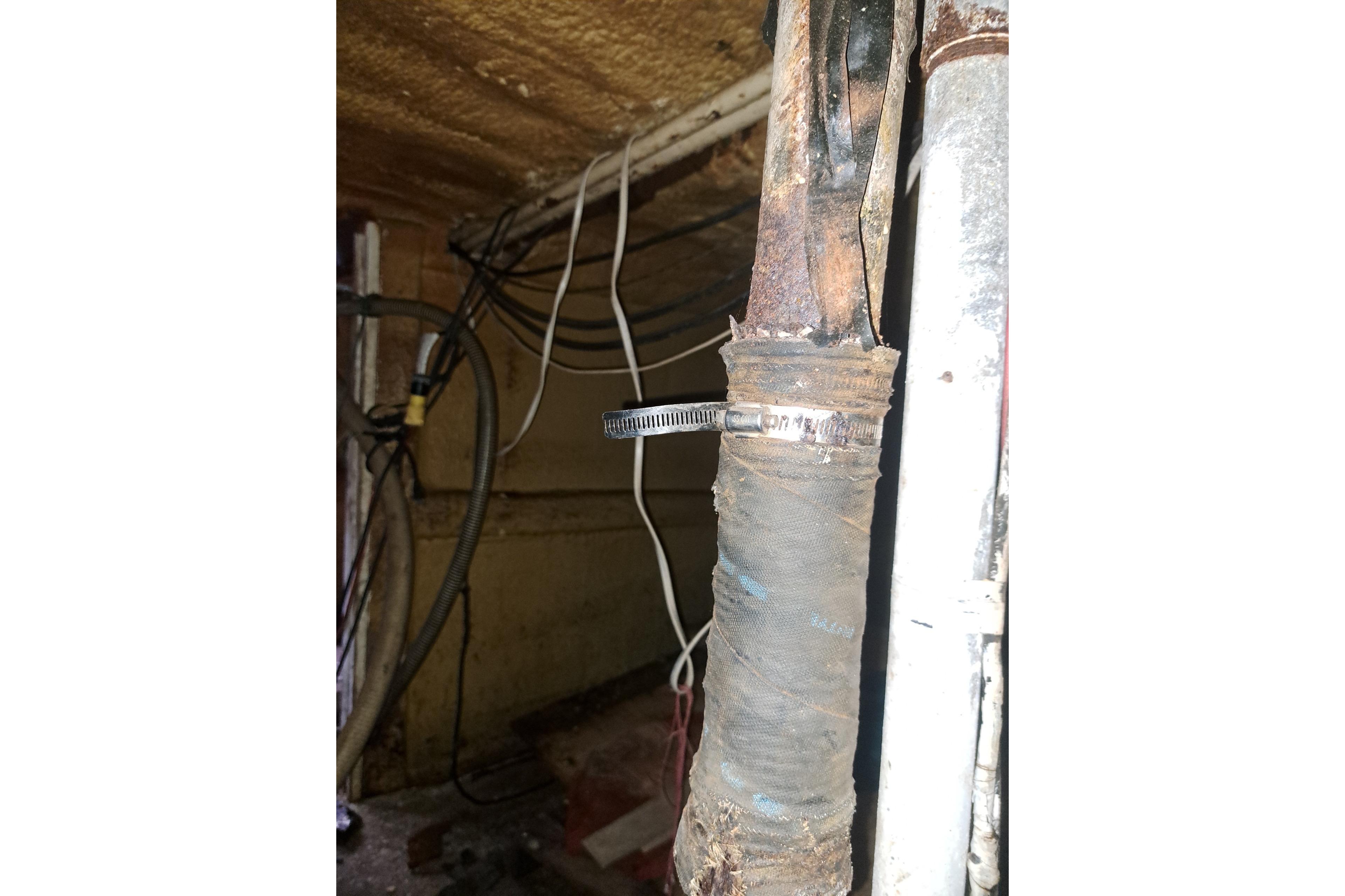 Old wiring and pipes in a 1979 Custom Steel Trawler Dragger's engine room.