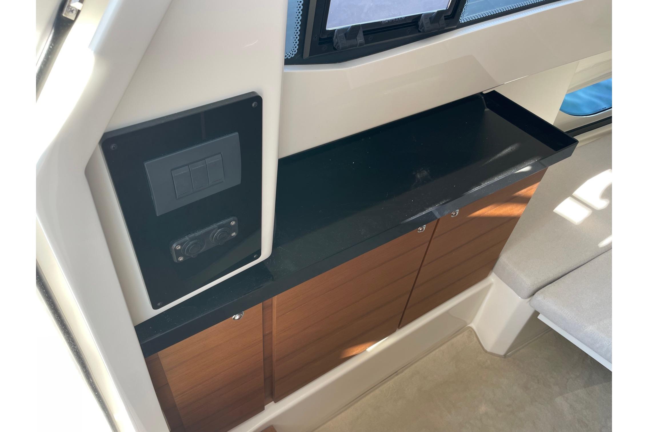 Interior view of 2025 Joker Boat Clubman 35, featuring sleek cabinetry and control panel.