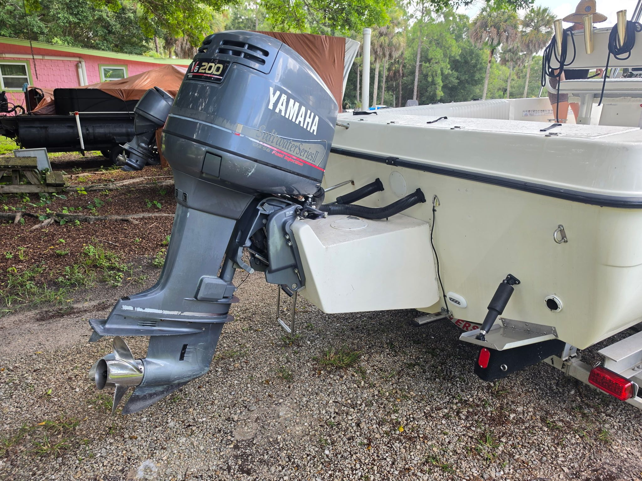 A 2004 Hydra-Sports Lightning 230 CC with a Yamaha outboard motor, parked on a gravel area.