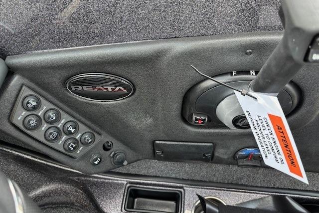 Control panel of 2026 Ranger 212LS boat with Reata branding and warning tag.