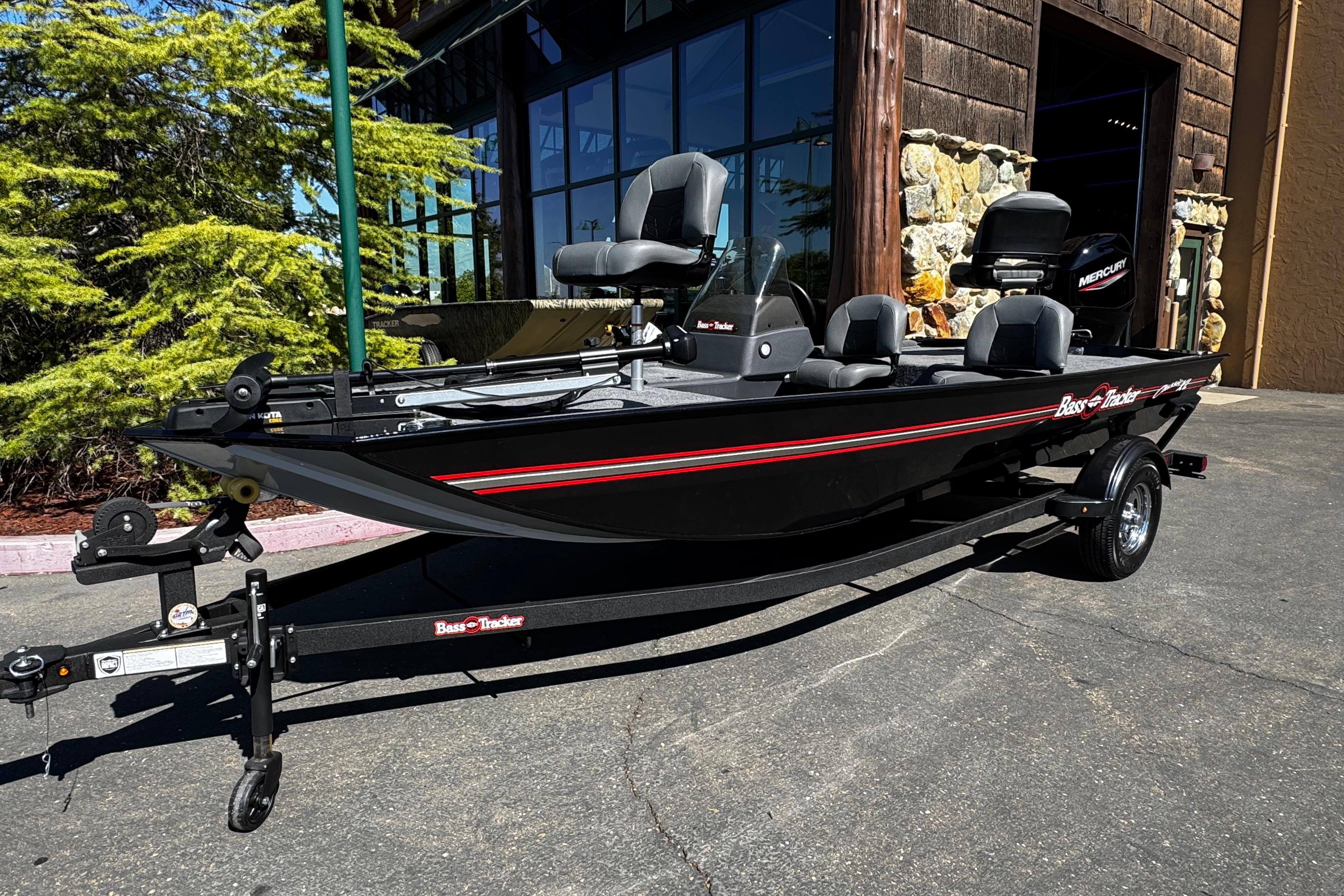2026 Tracker Bass Tracker Classic XL boat on trailer, parked outdoors.