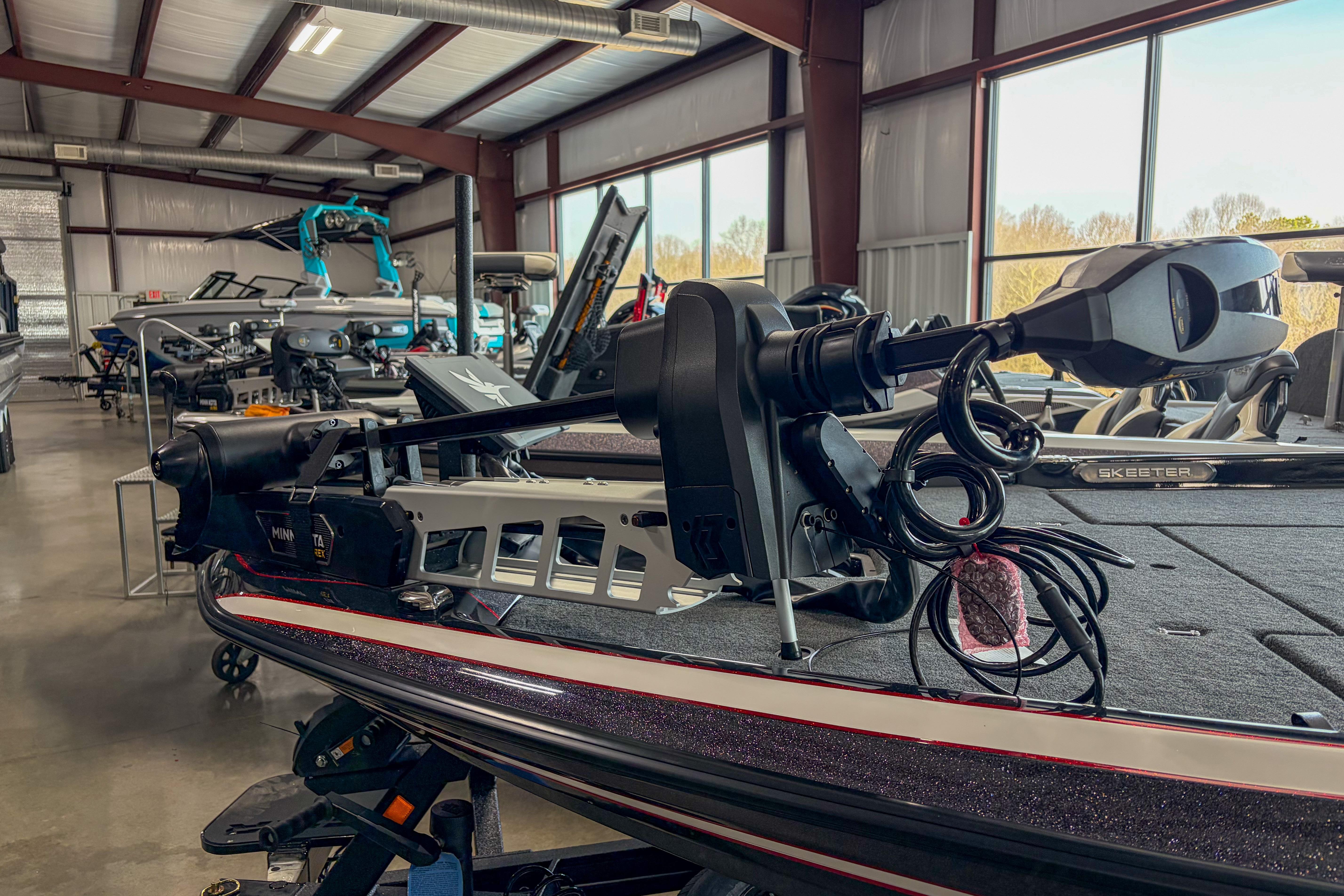 2026 Skeeter FXR20 FLEX boat in showroom with advanced trolling motor.