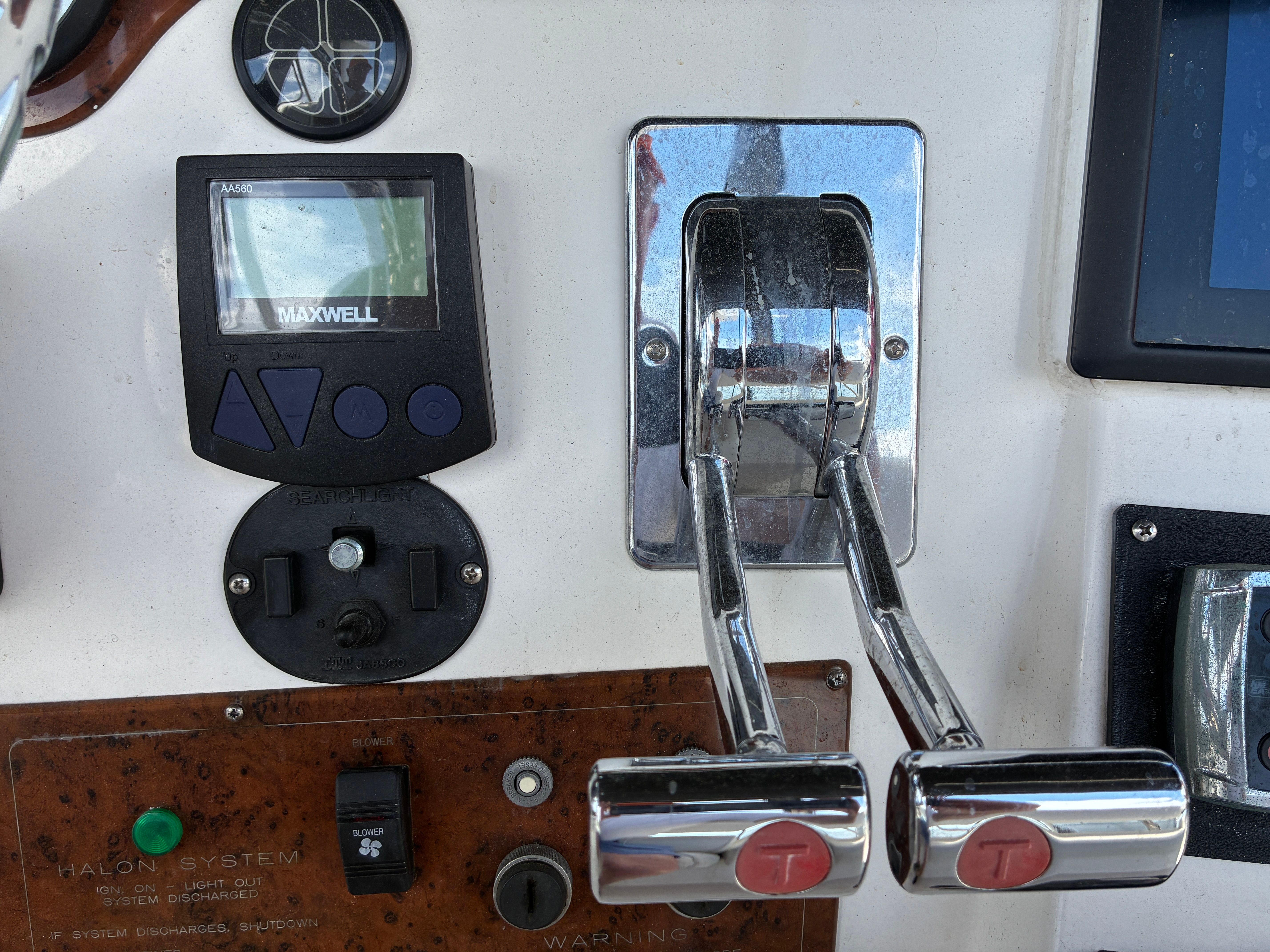 Close-up of the control console on a 2001 Silverton 392 Motor Yacht with levers and instruments.