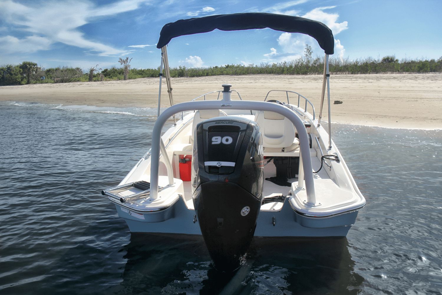 Boston Whaler 160 Super Sport at the beach with an outboard motor.