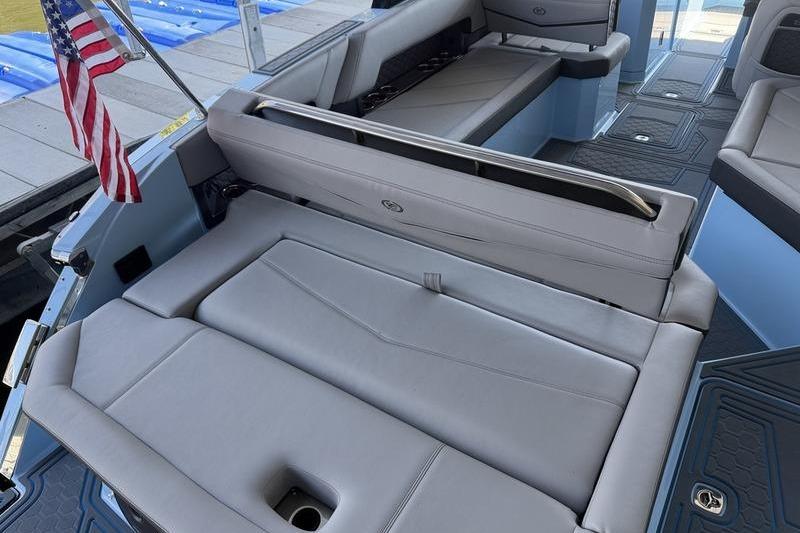 2026 Cobalt R8 Surf boat interior with gray seating and American flag.