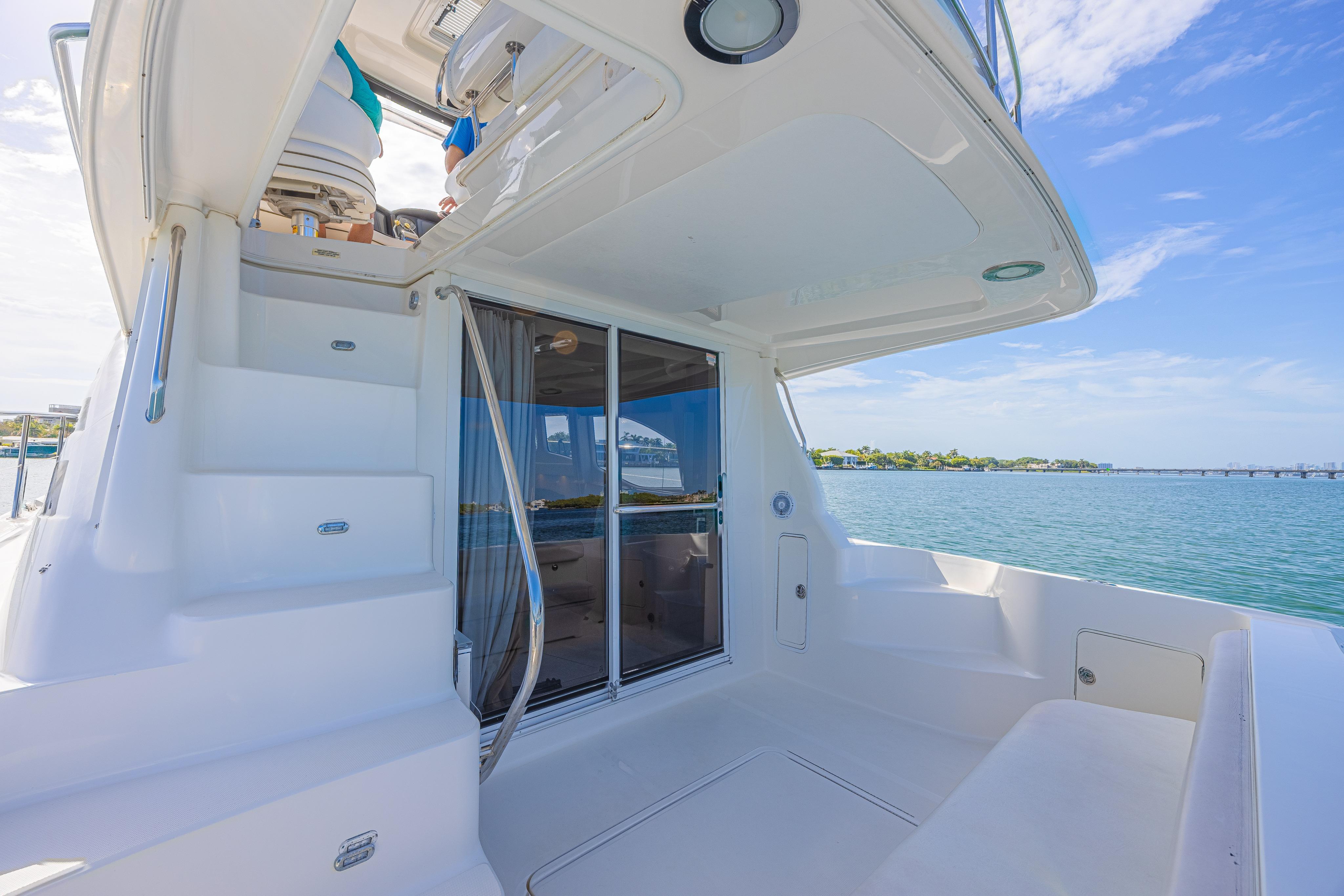 2007 Sea Ray 44 Sedan Bridge yacht with spacious deck and ocean view.