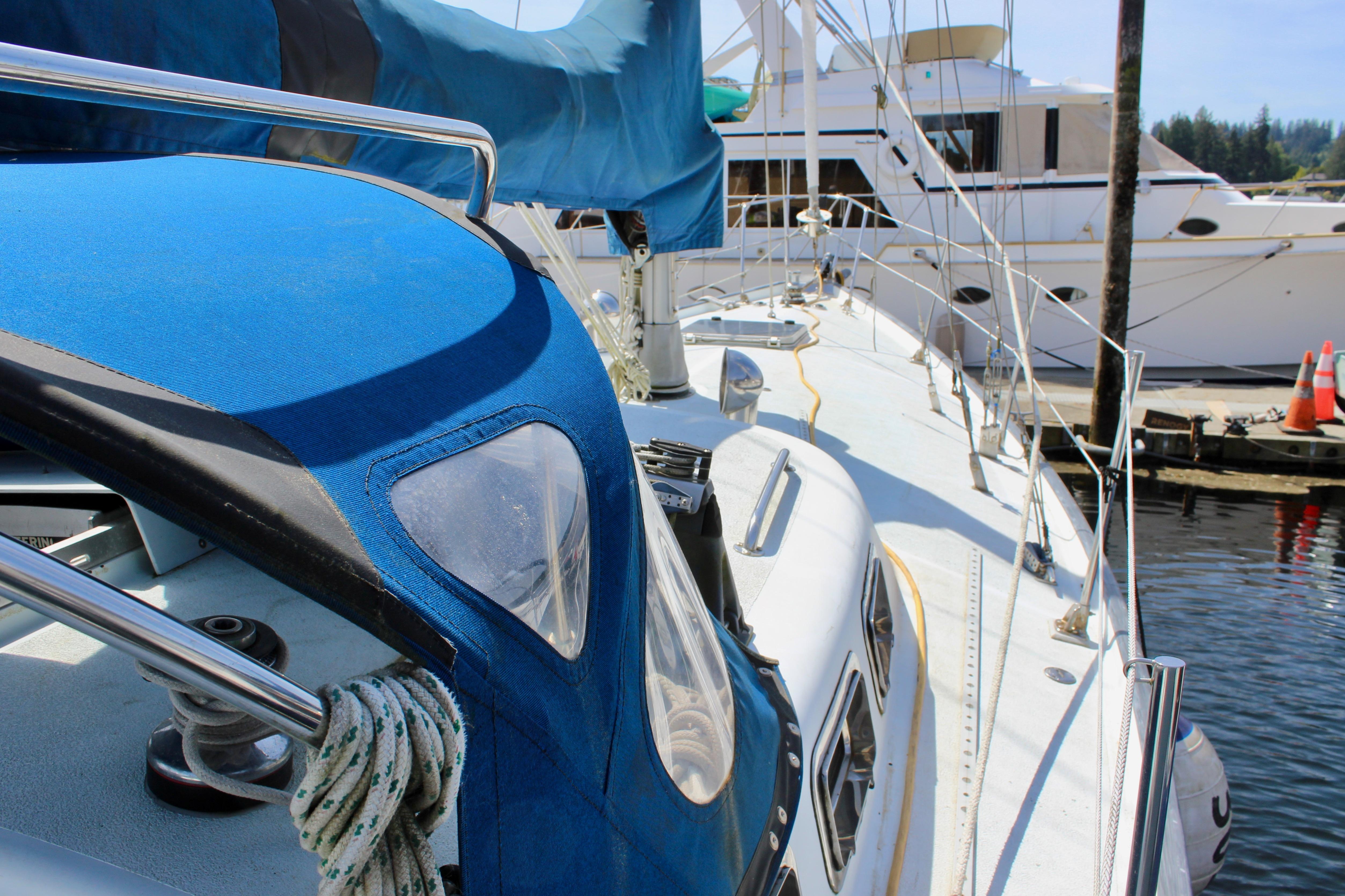 Sailboat Freya 39, 1993 model, docked at marina with blue canopy.