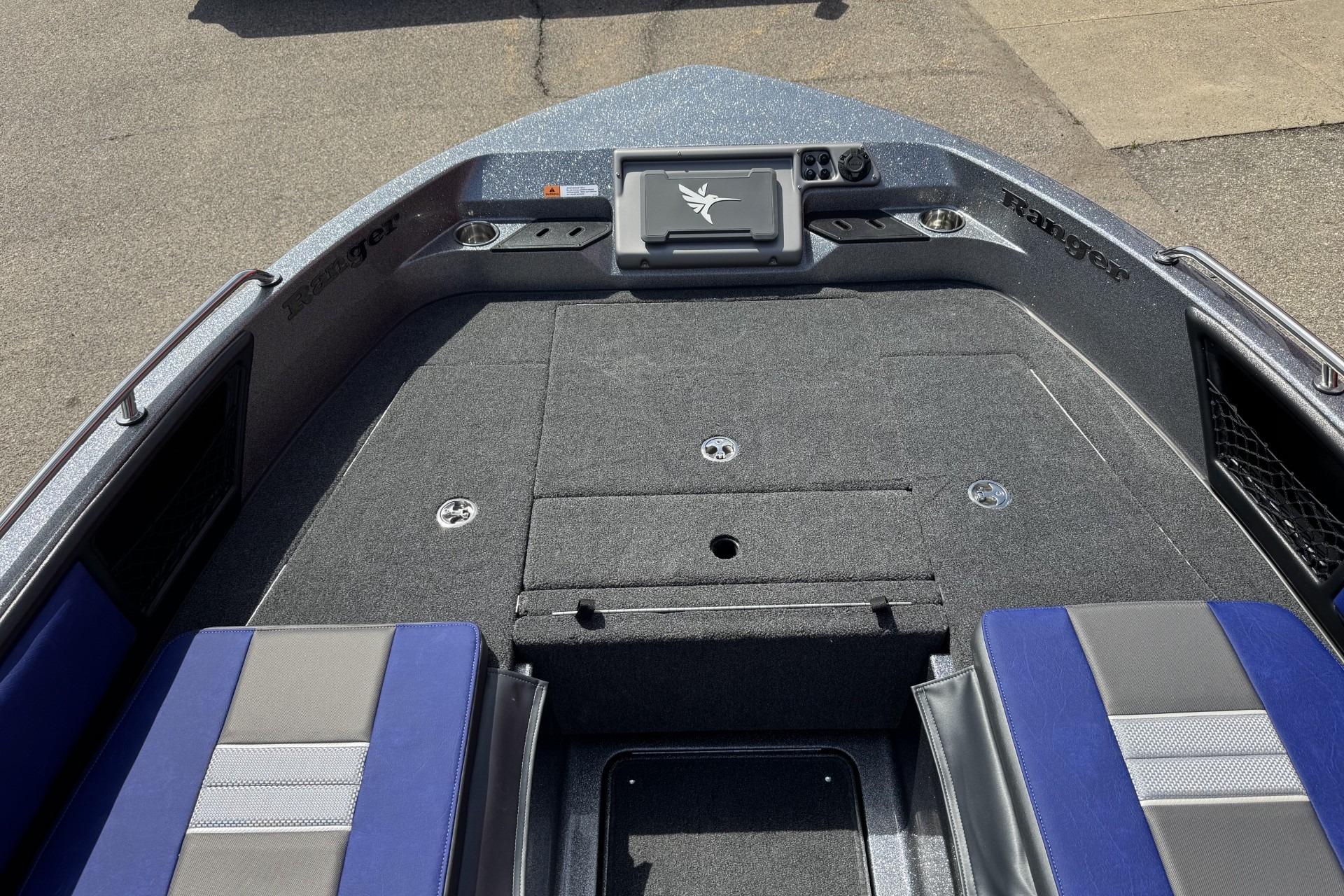 2026 Ranger 2050MS boat interior with gray and blue seating, carpeted deck, and control panel.