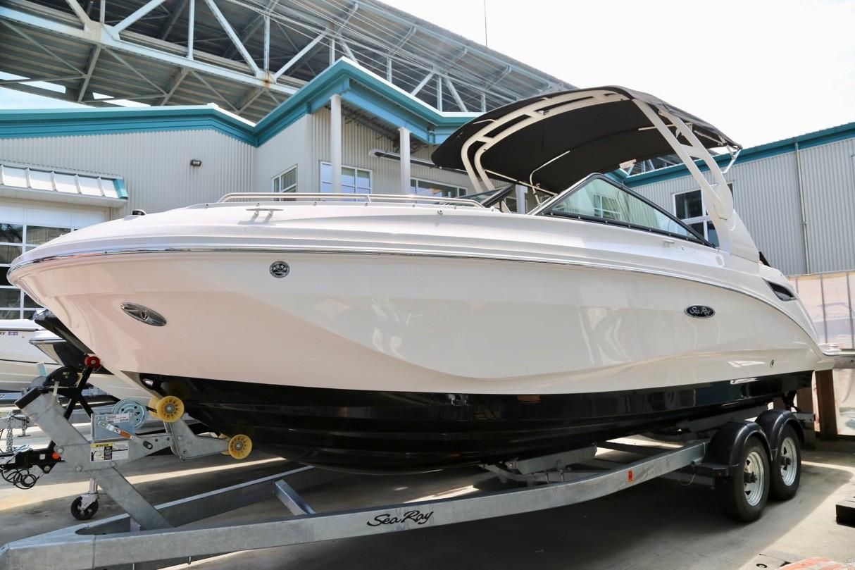 2019 Sea Ray SDX 250 boat on trailer in front of building.