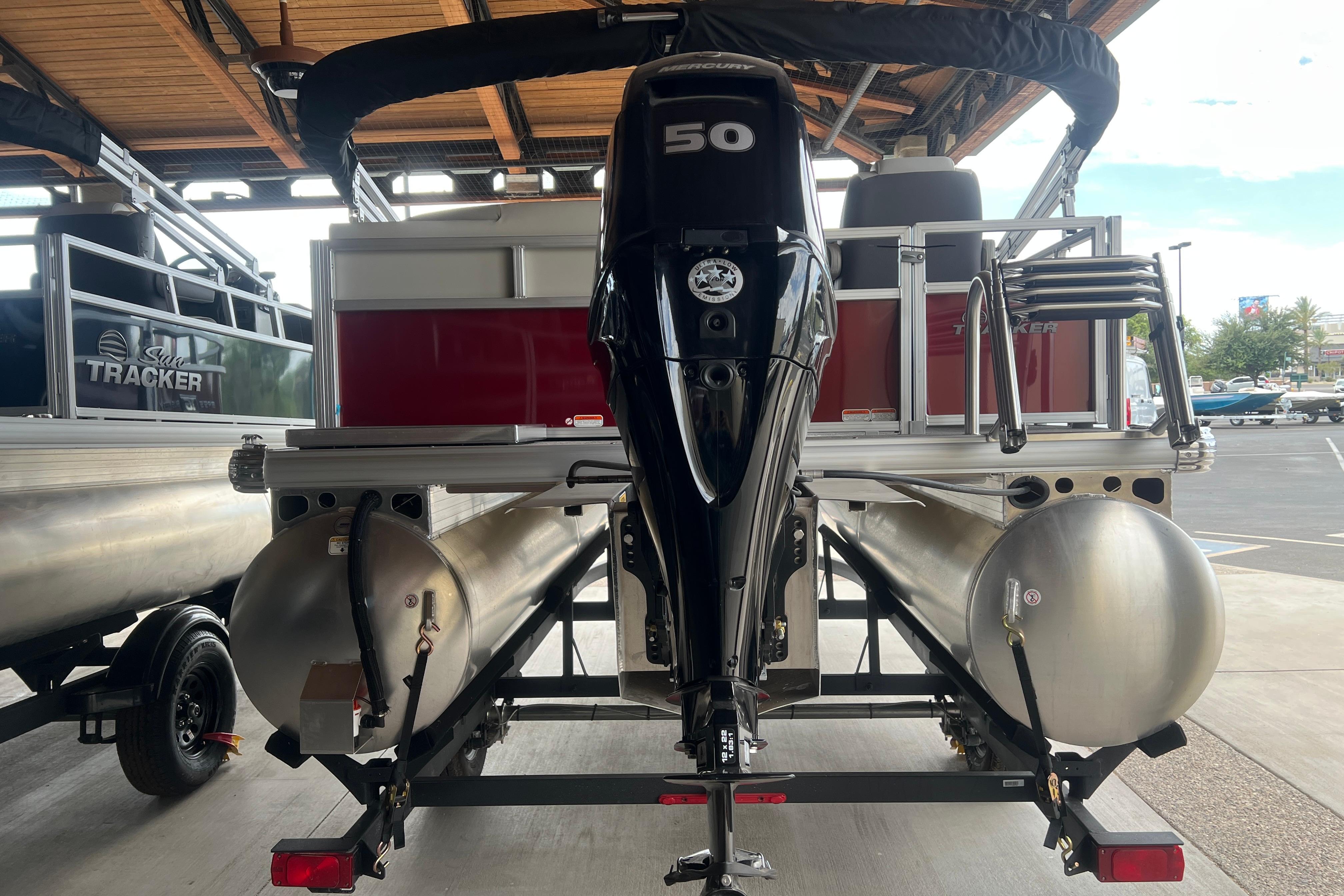 2026 Sun Tracker Bass Buggy 16 XL Select pontoon boat with Mercury 50 engine, rear view.