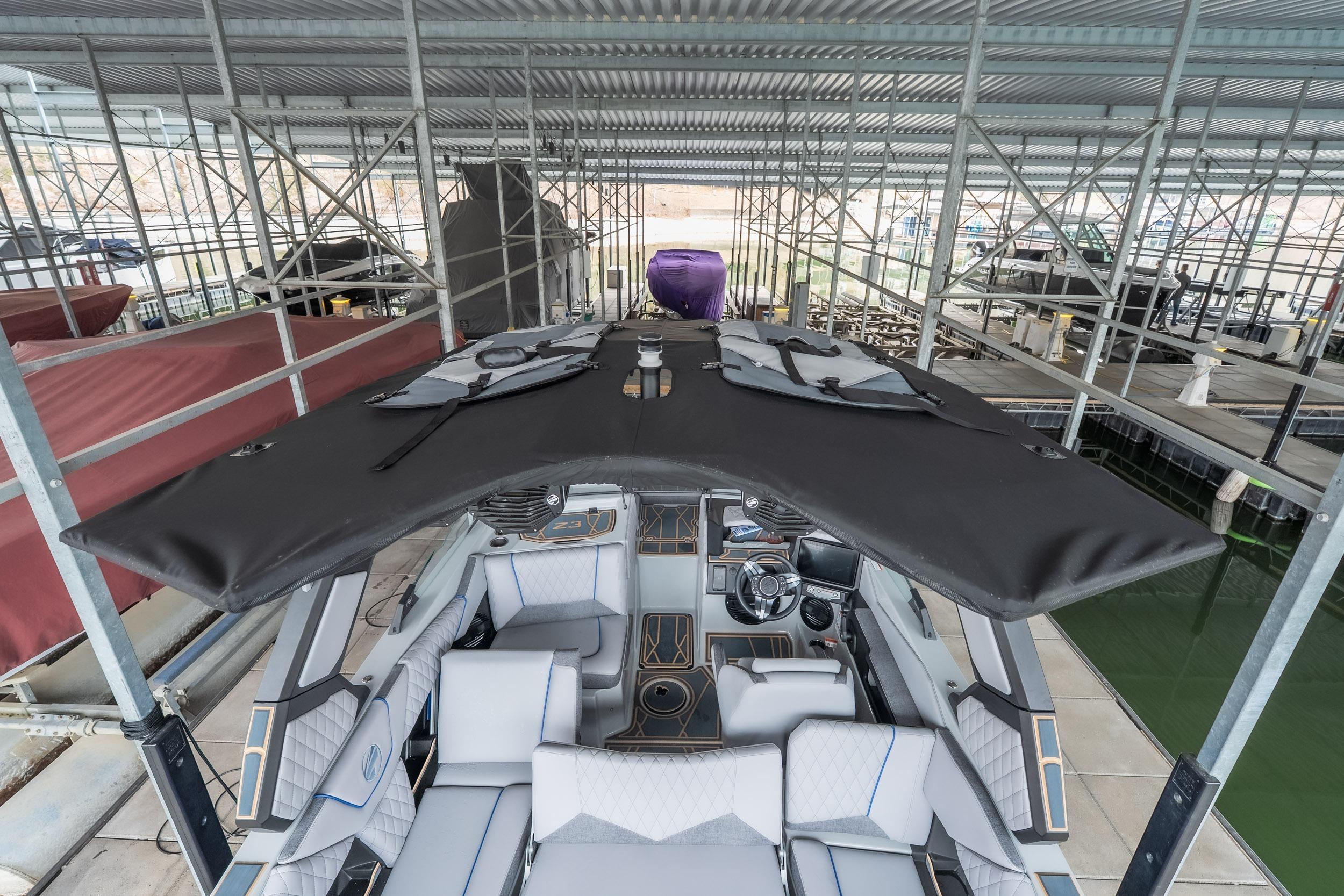 2026 Tigé Z3 boat docked under a metal canopy, showcasing sleek design and modern features.