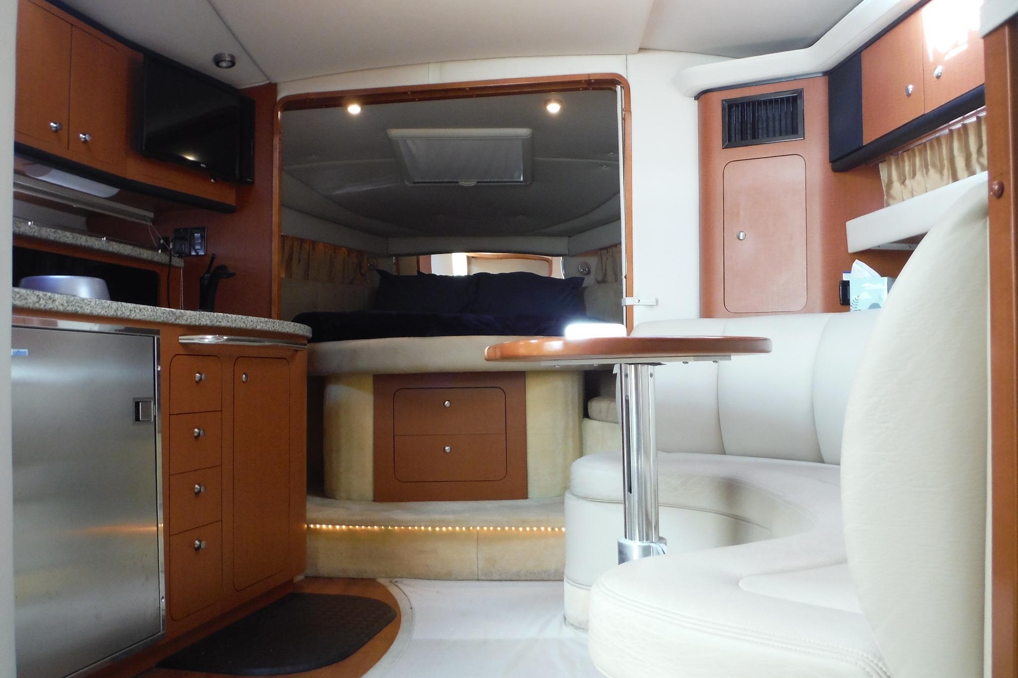 Luxurious interior of 2005 Chaparral Signature 350 yacht with modern amenities and cozy seating.