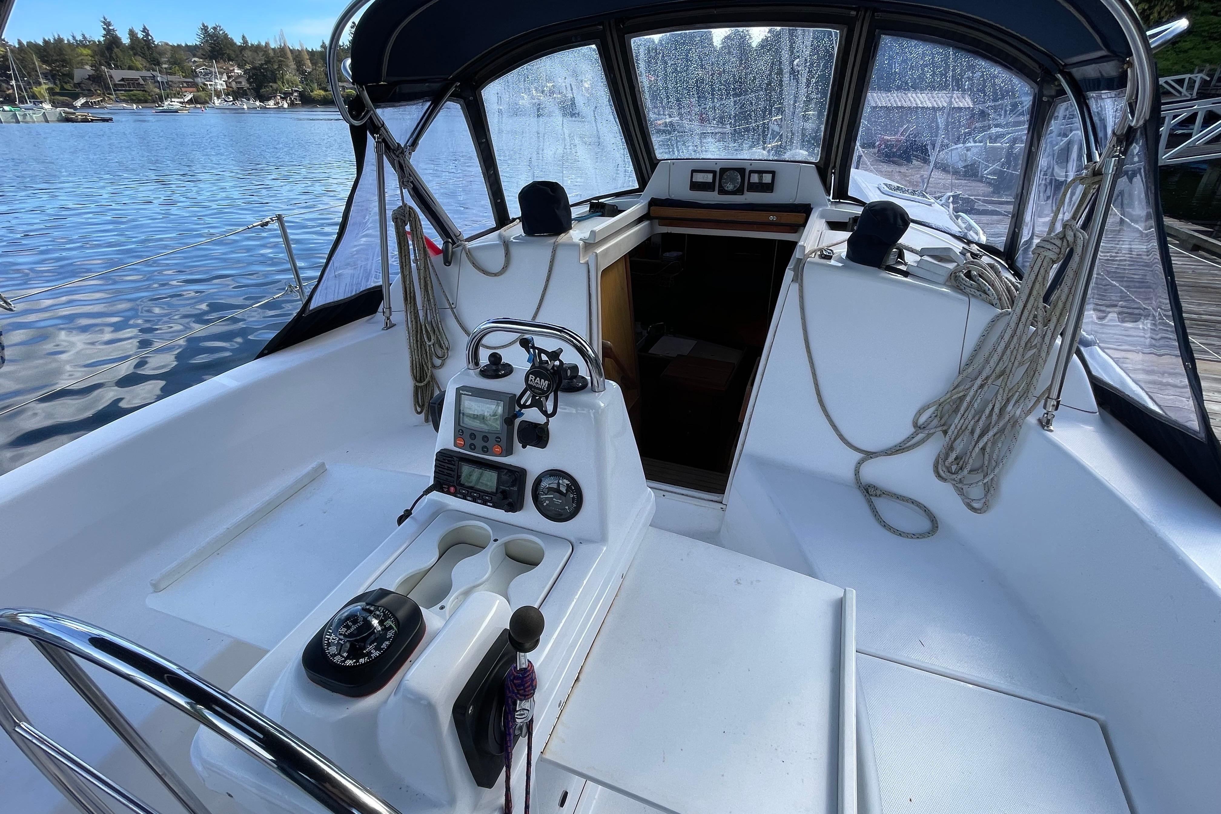 Cockpit of a 2000 Hunter 340 sailboat with navigation instruments and ropes.