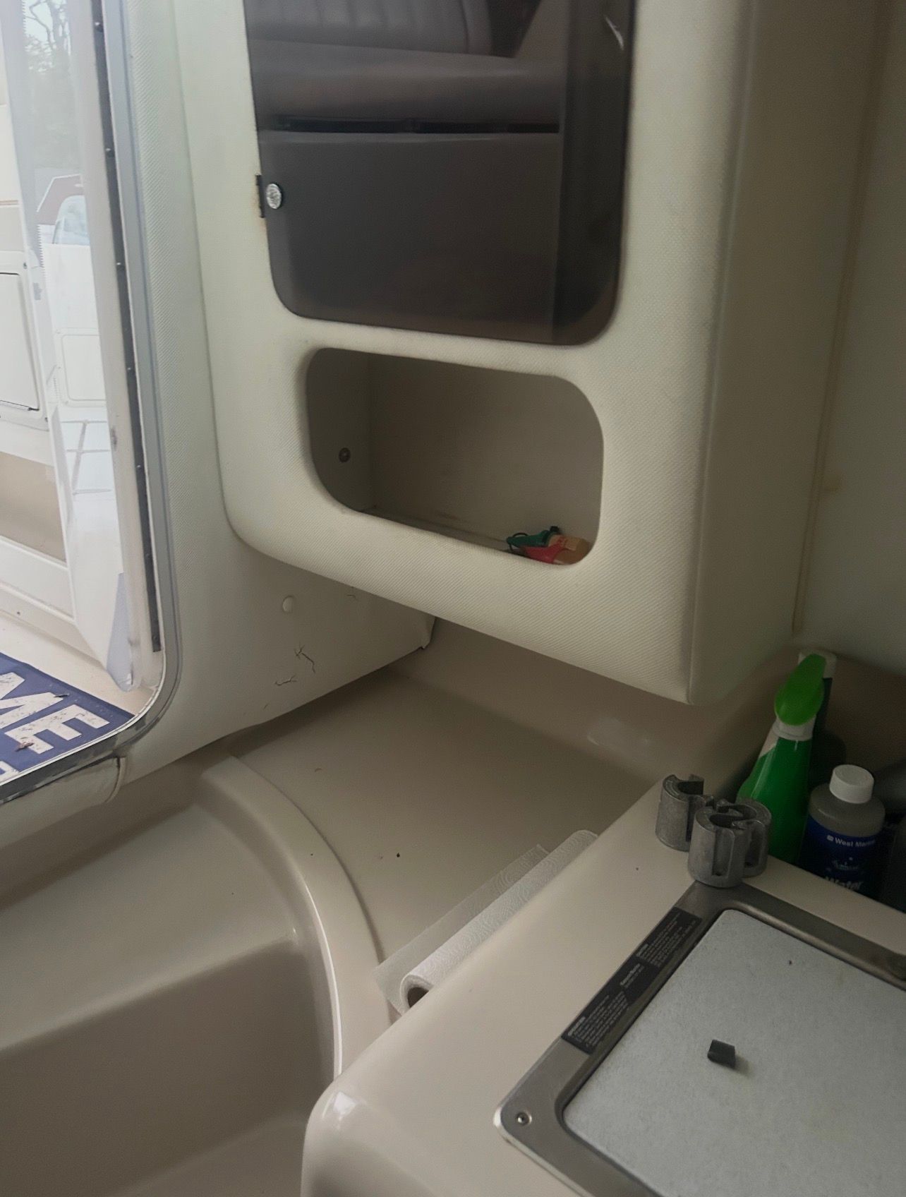 Interior of a boat with storage space and a sink.