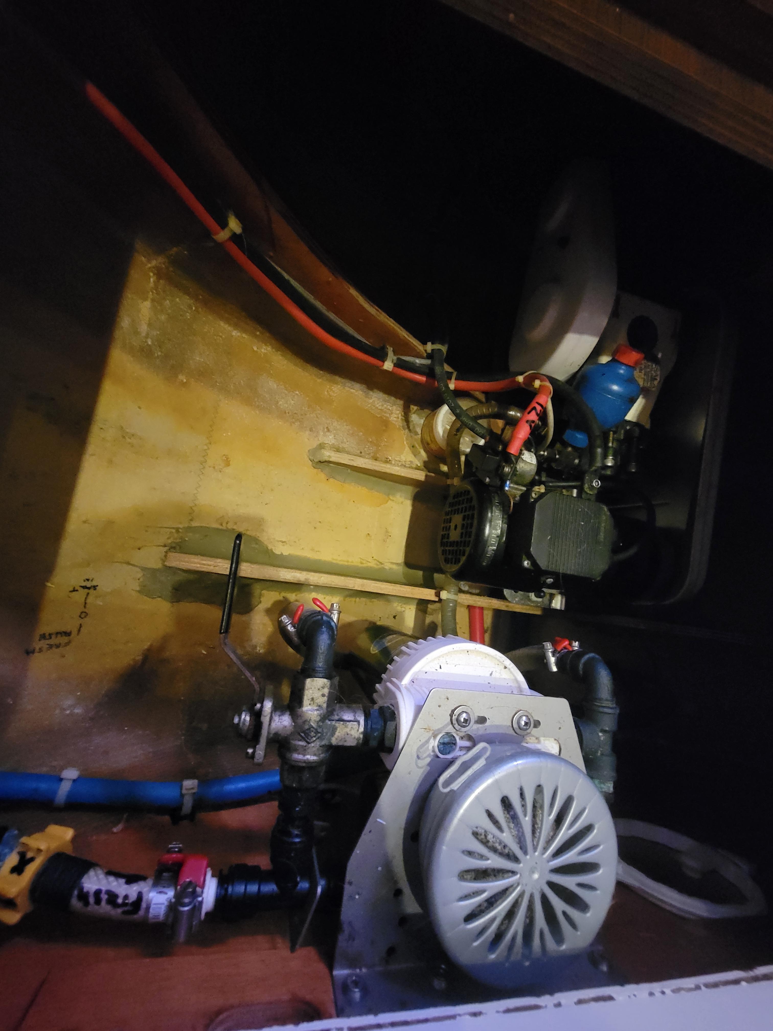 Engine compartment of a 2011 Lagoon 450 catamaran, showcasing mechanical components and wiring.