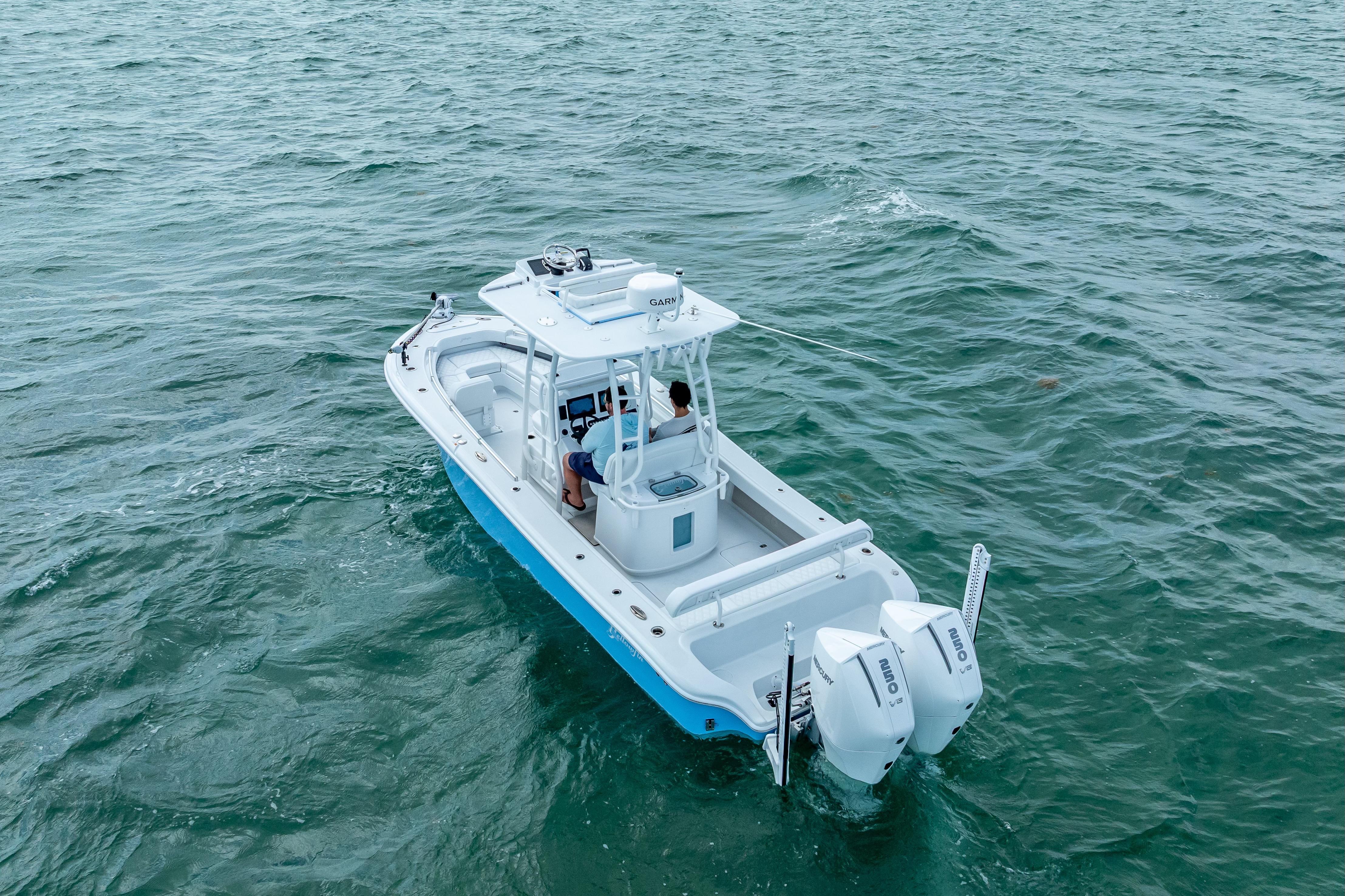 2026 Yellowfin 26 Hybrid boat cruising on open water, featuring dual outboard engines.