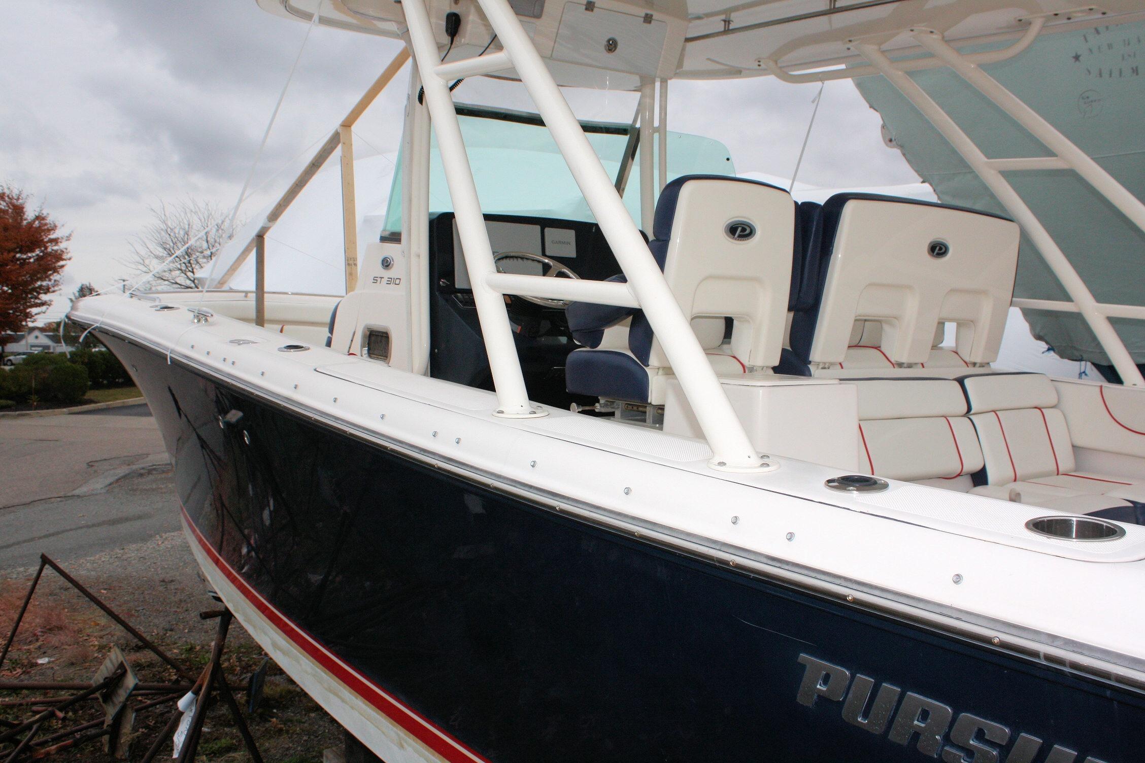 2013 Pursuit ST 310 Sport boat with white seating and sleek design.