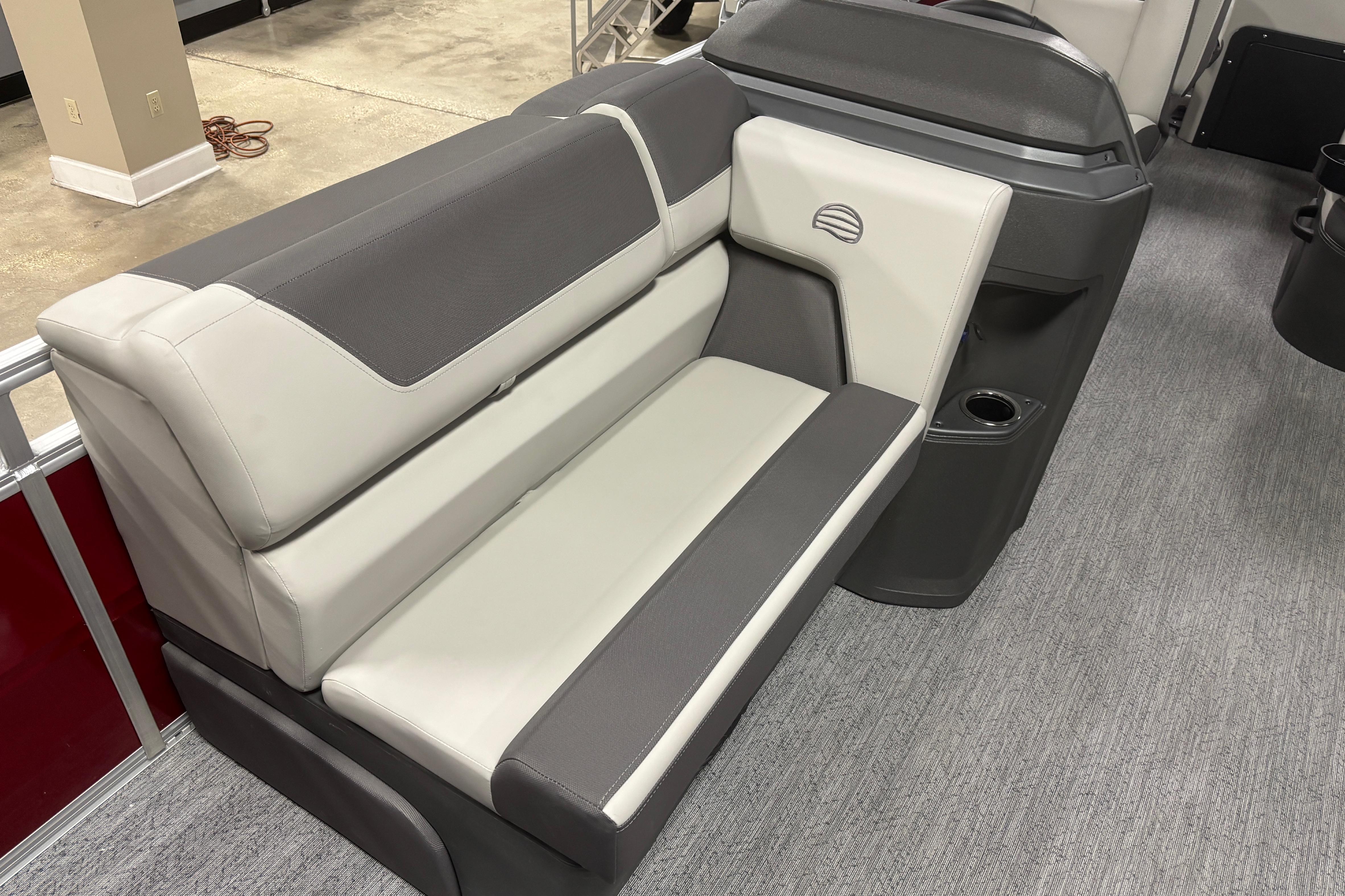 2026 Sun Tracker Fishin' Barge 22 DLX interior seating with gray and white upholstery.
