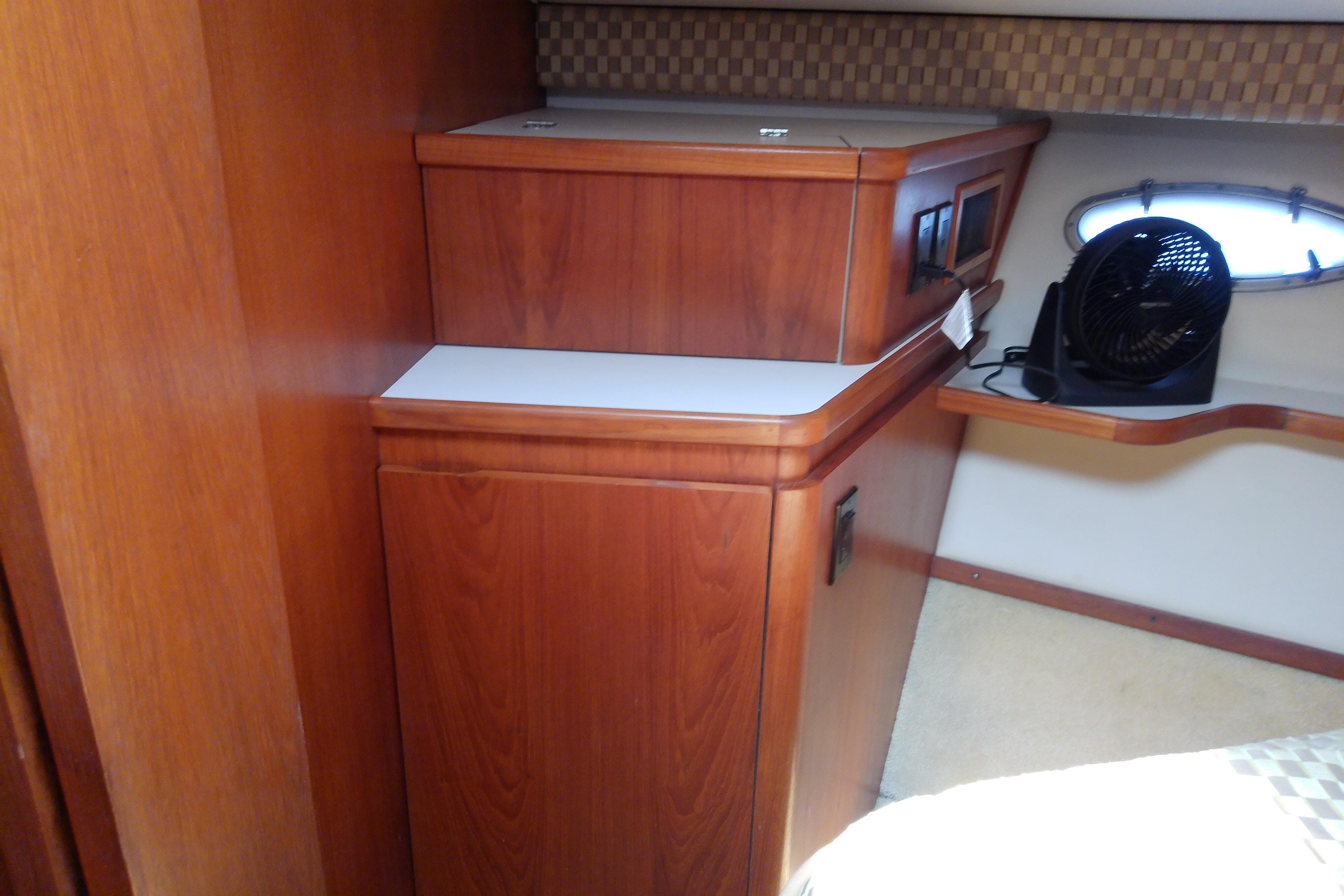 Interior of 2000 Tiara Yachts 4100 Open with wooden cabinetry and small fan.
