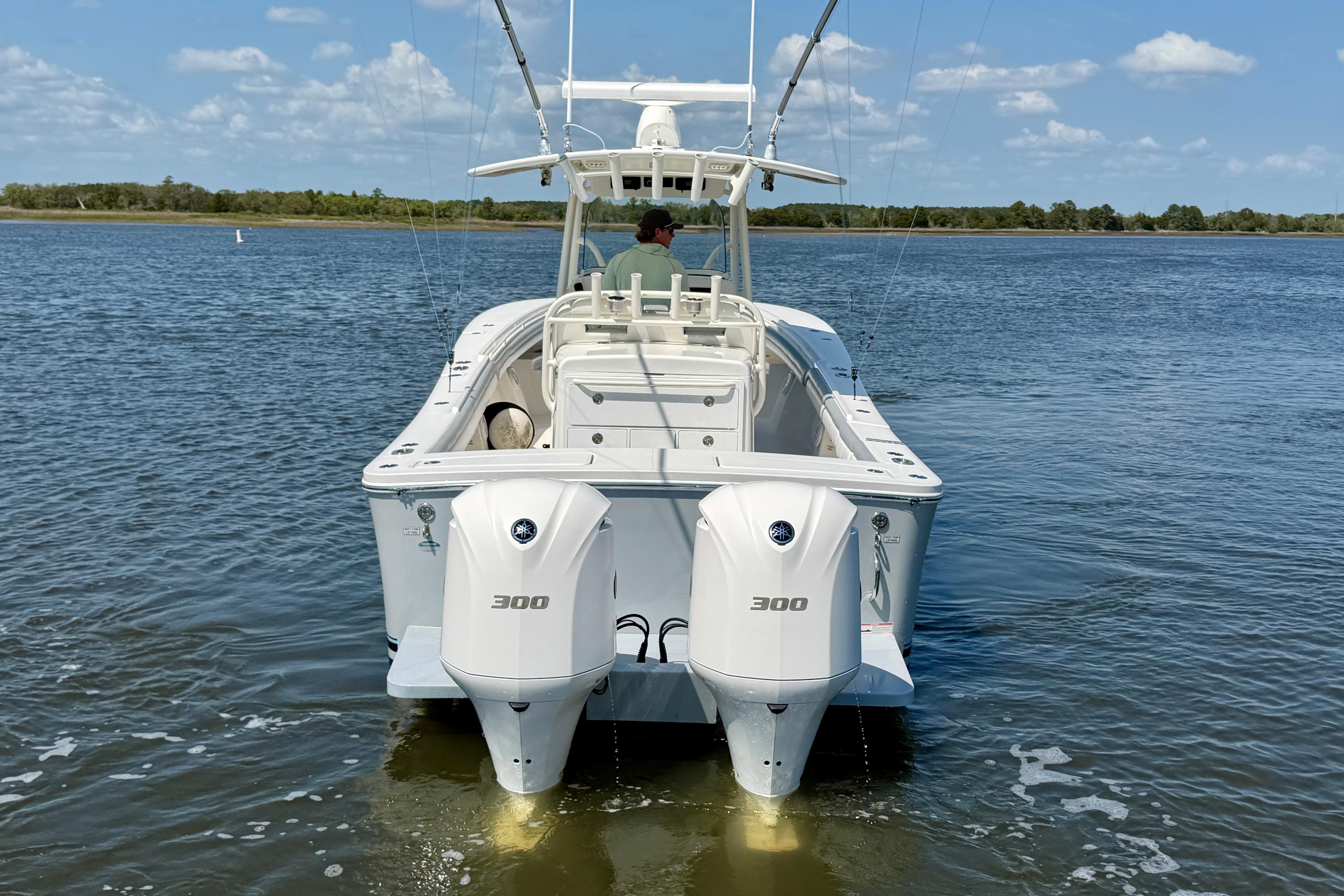 2019 Regulator 31 boat with dual 300 horsepower engines on calm water.