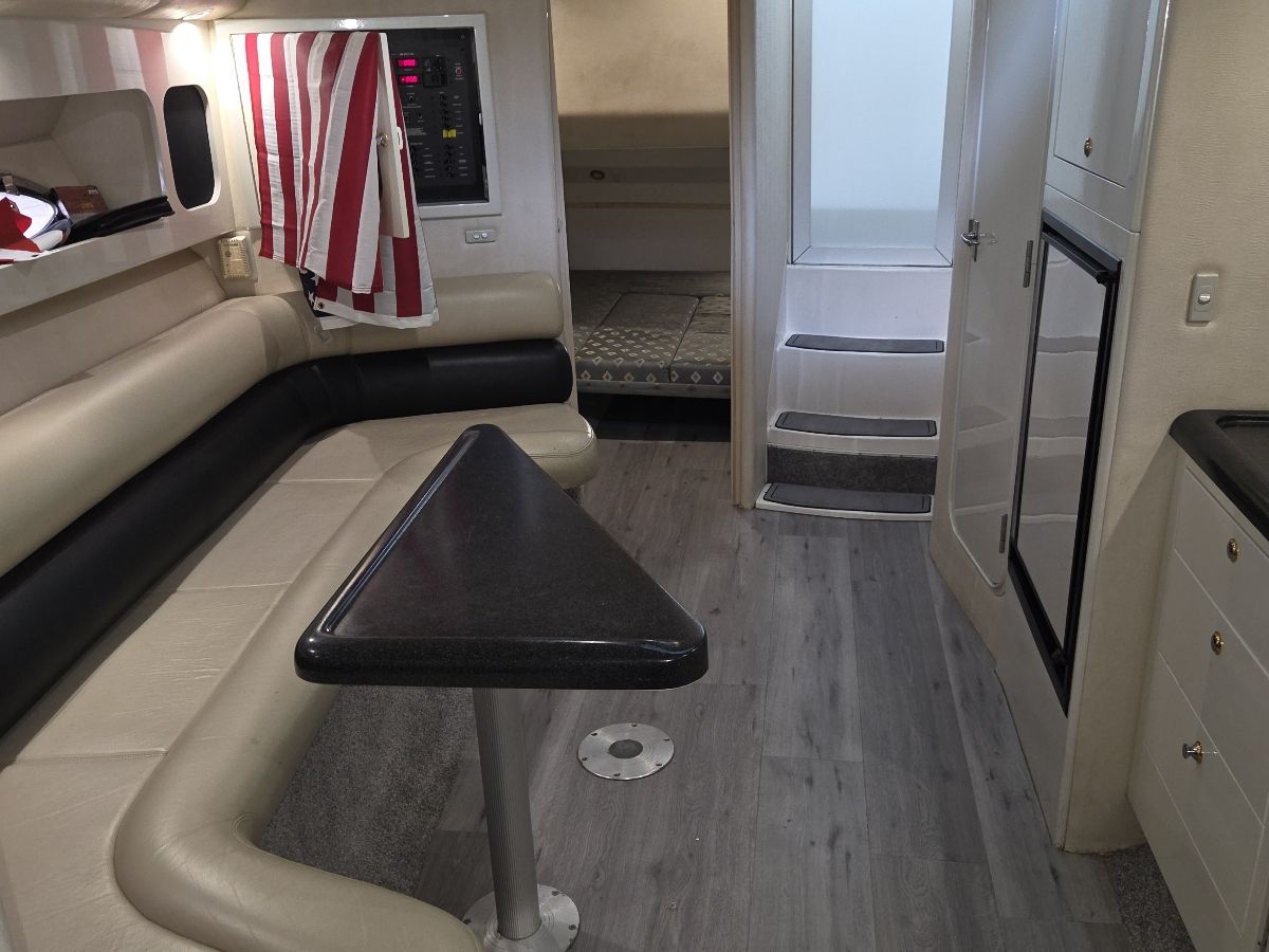 Interior of a 2000 Weldcraft Excalibur 45 with seating area, table, and cabin.