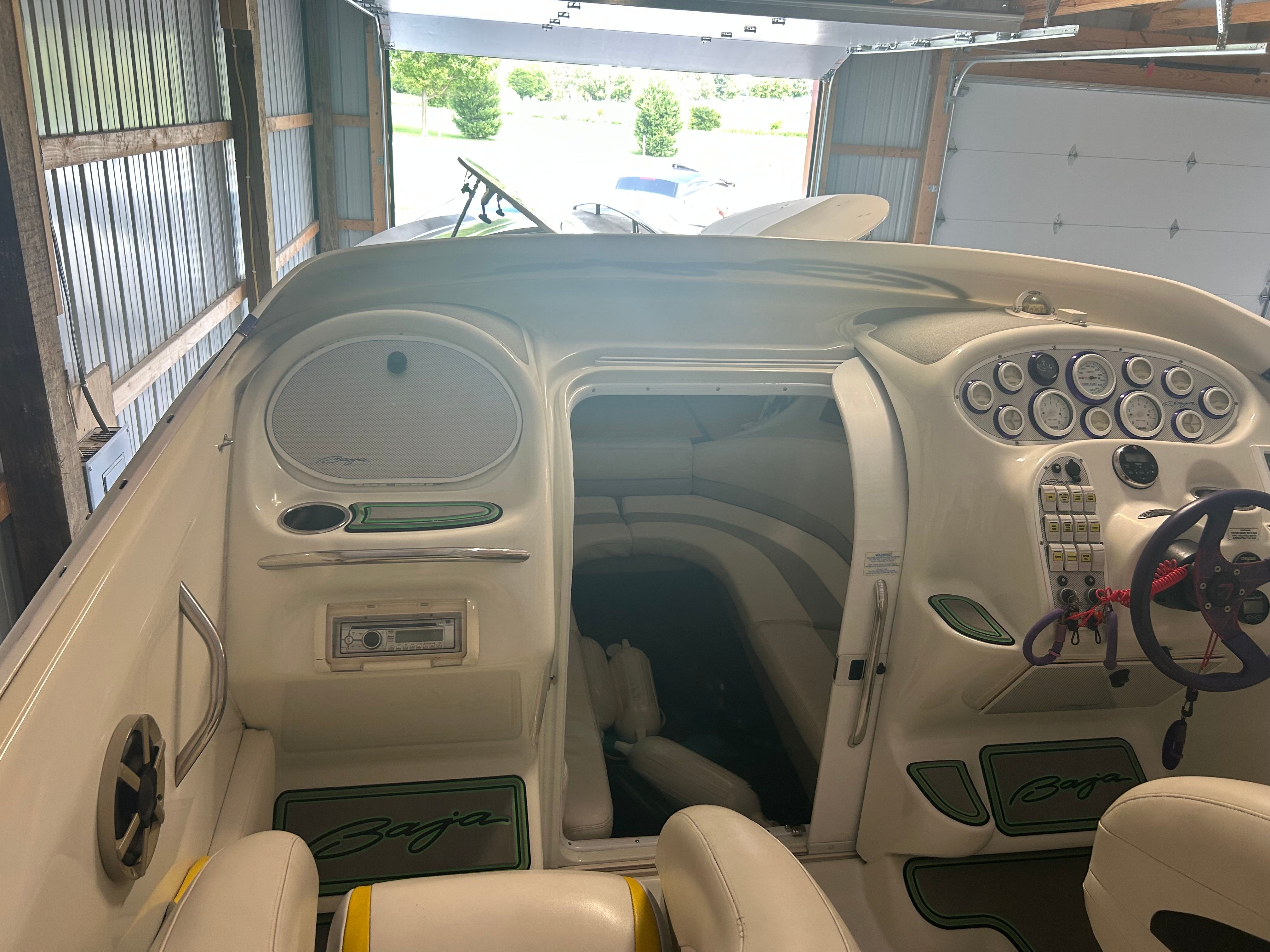 Interior view of a 1996 Baja 302 boat with steering console and seating area.