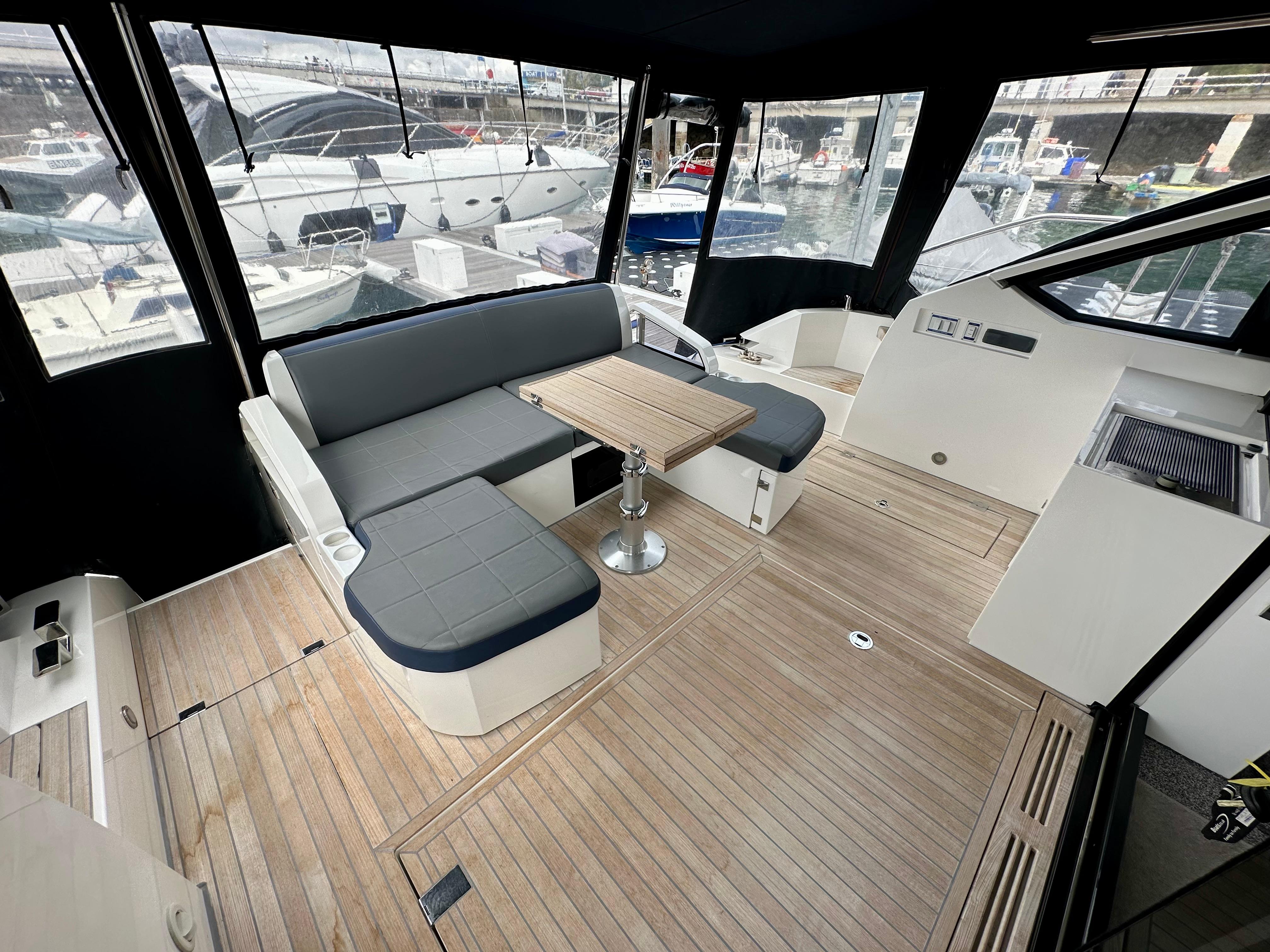 Interior of 2012 Fairline Targa 50 GT yacht with seating and wooden flooring.