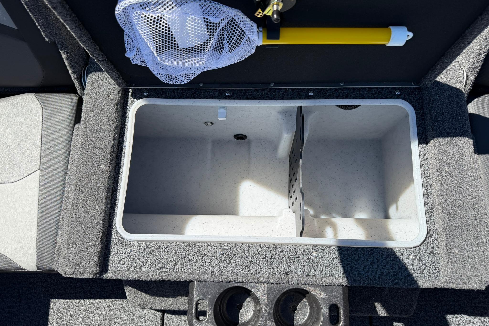 Livewell compartment in 2027 Lund 1775 Crossover XS boat, featuring dual sections and cup holders.