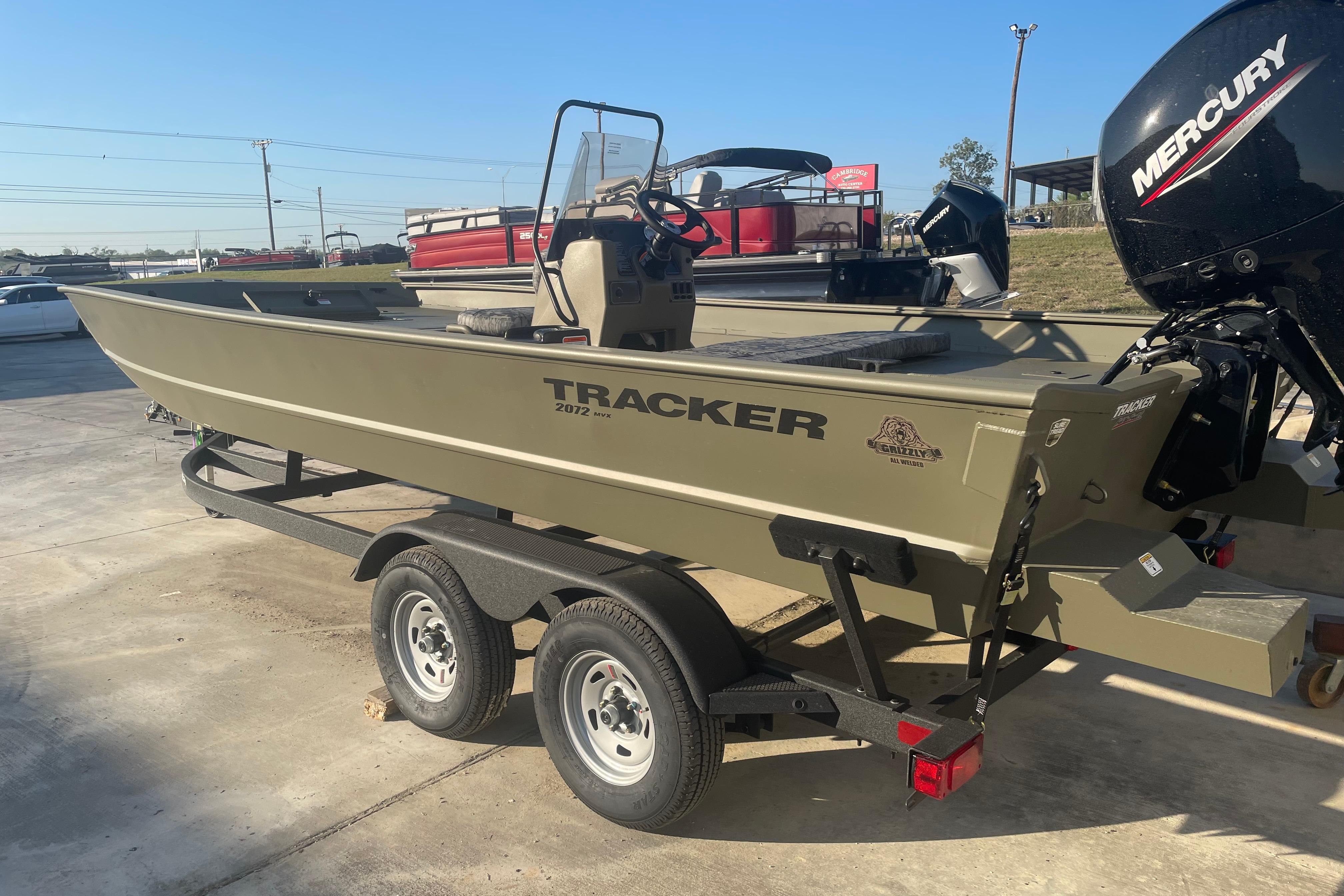 2026 Tracker Grizzly 2072 CC boat on trailer, featuring a Mercury outboard motor.
