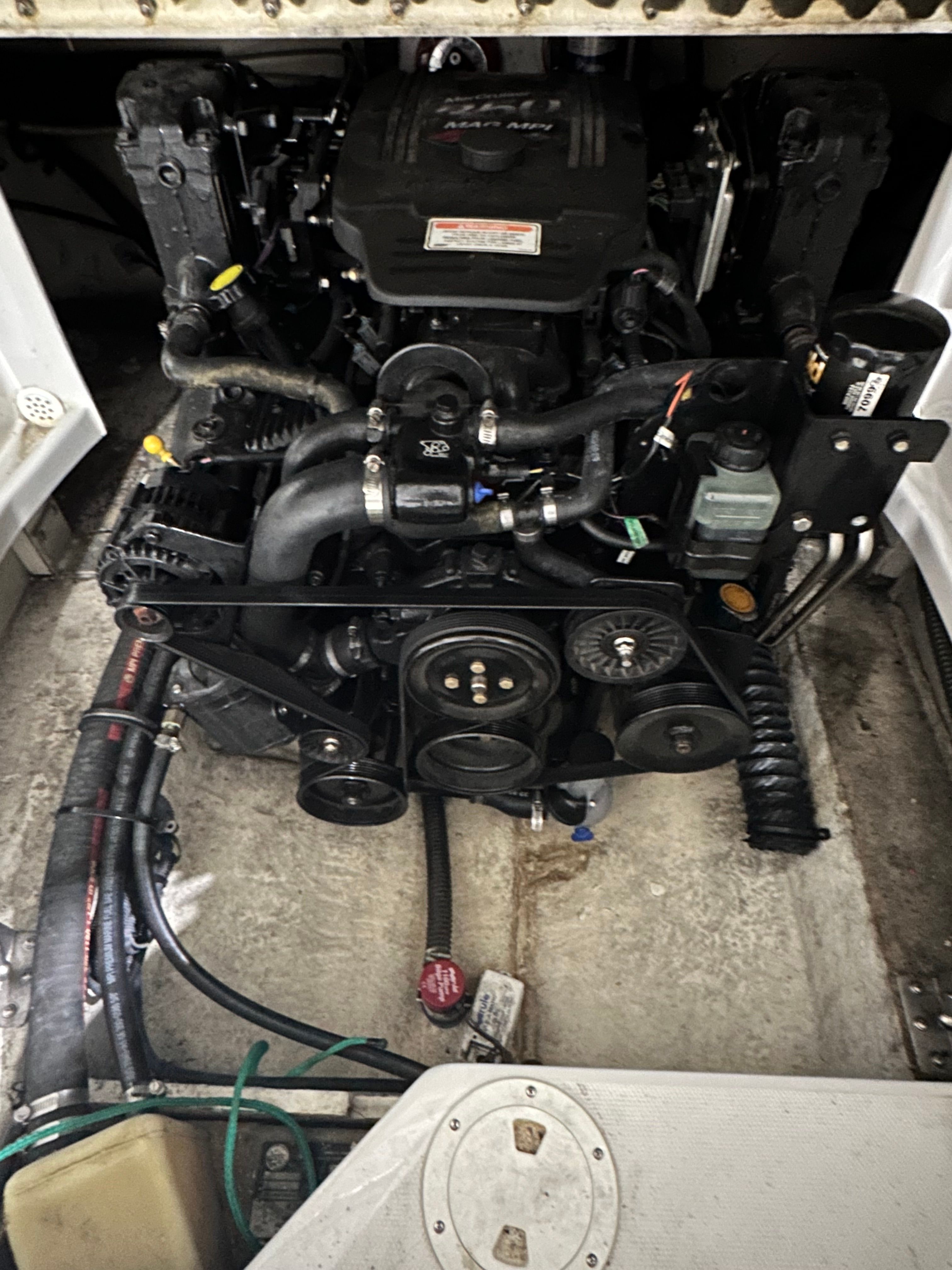 Engine compartment of a 2007 Crownline 252 EX boat with visible engine and hoses.