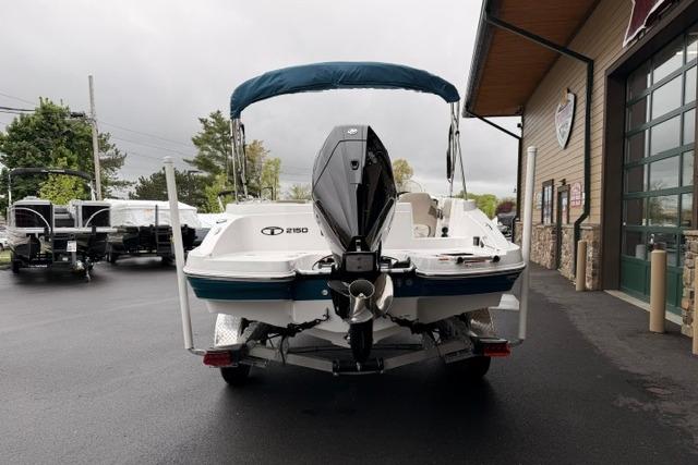 2026 Tahoe 2150 boat with outboard motor, parked outside a building on a cloudy day.
