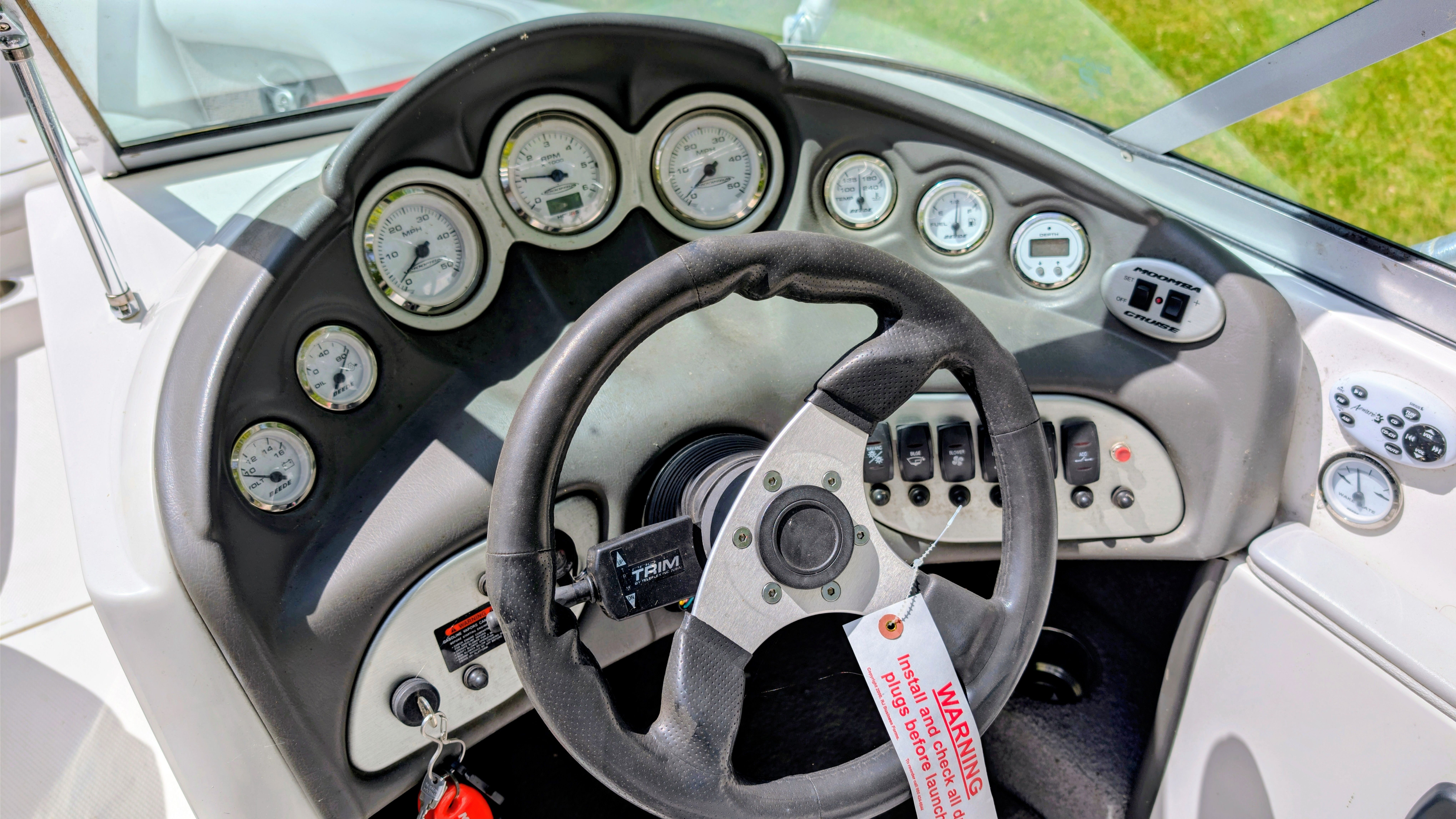 Dashboard of a 2007 Moomba Outback V boat with steering wheel and gauges.