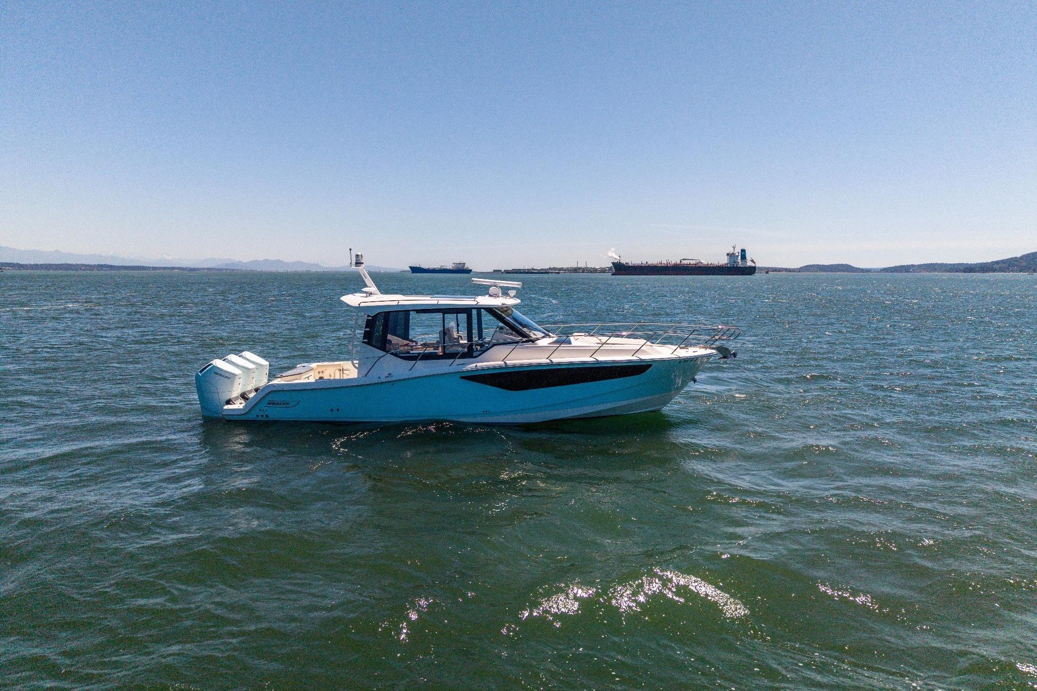 2023 Boston Whaler 405 Conquest boat on open water, clear sky background.