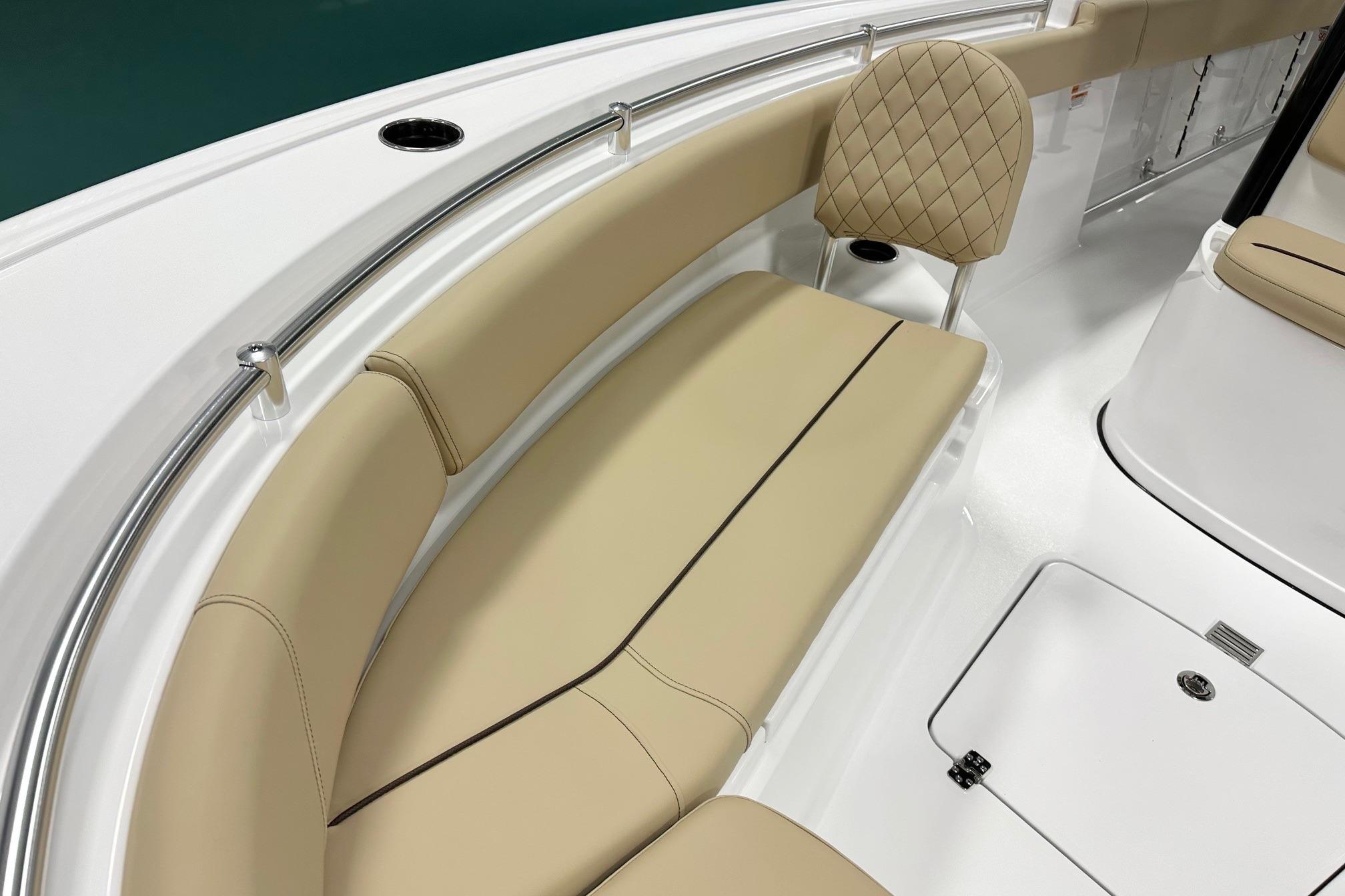2026 Sportsman Open 232 Center Console boat with beige seating and stainless steel railings.