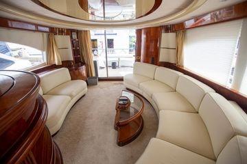 Luxurious interior of 2003 Azimut 74 Solar yacht with elegant seating and wood finishes.