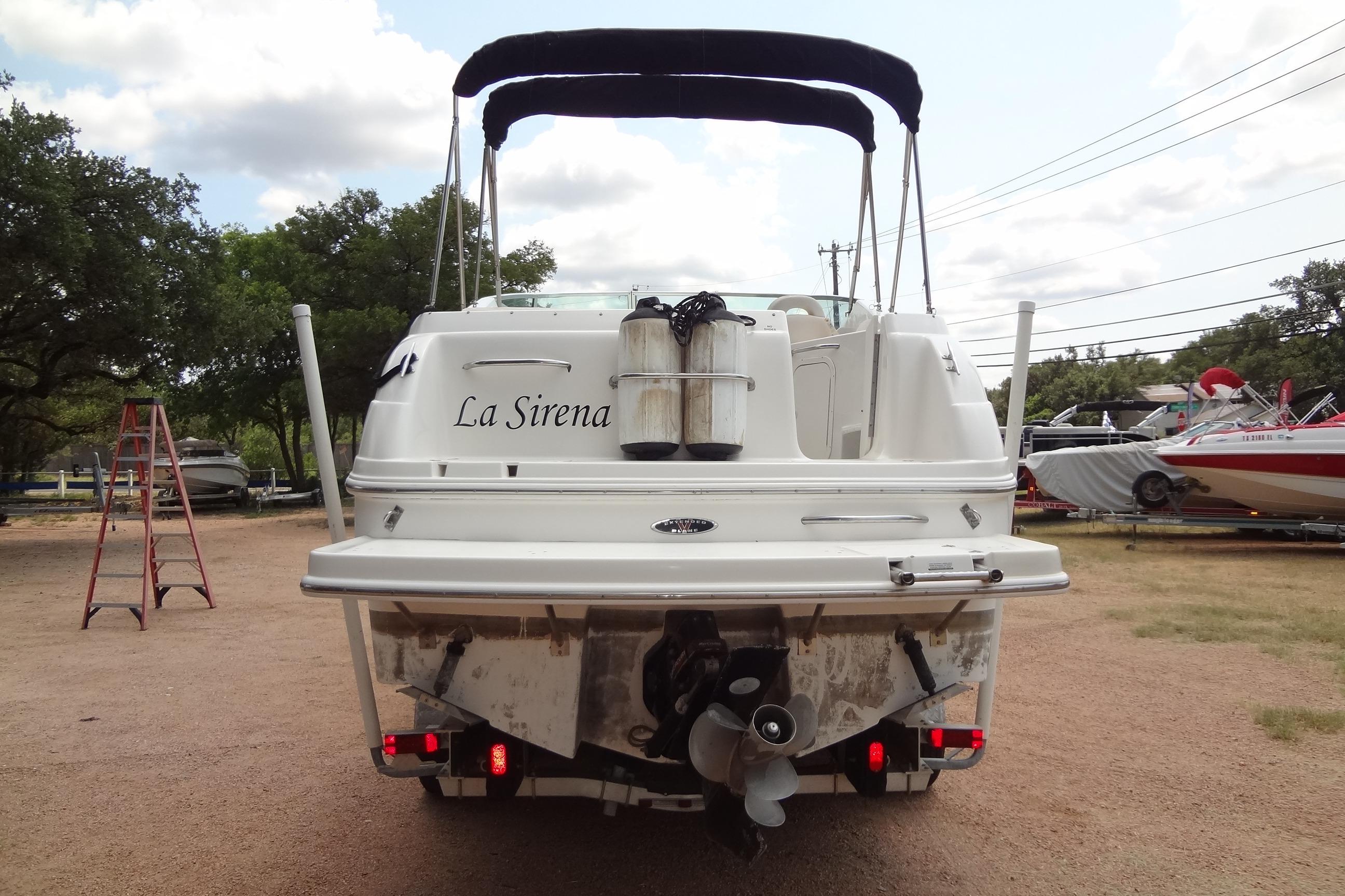 Rear view of 2000 Chaparral Signature 260 boat named "La Sirena" in a yard setting.