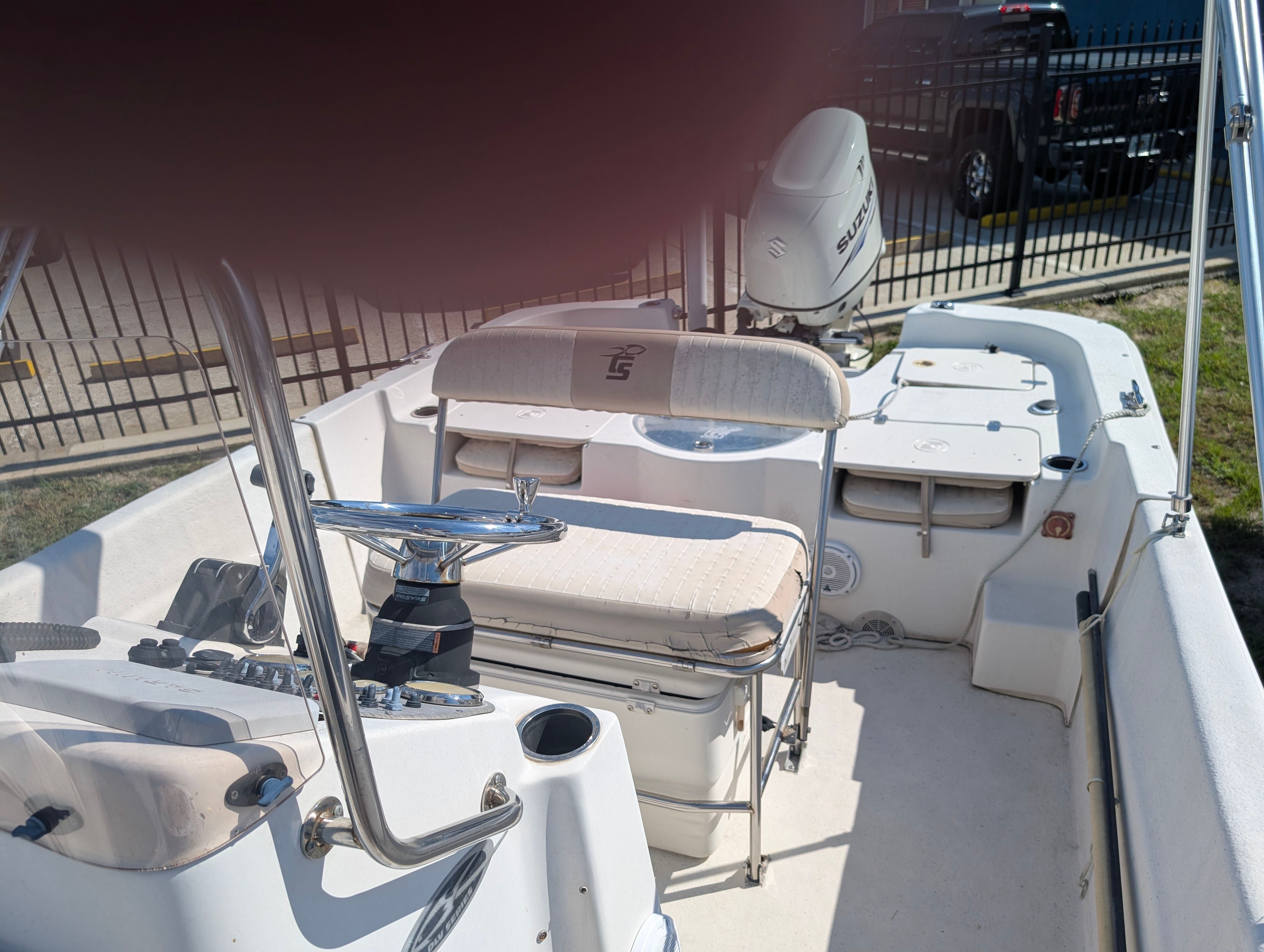 The image shows the cockpit of a 2016 Carolina Skiff 198 DLV with a bench seat and helm console.