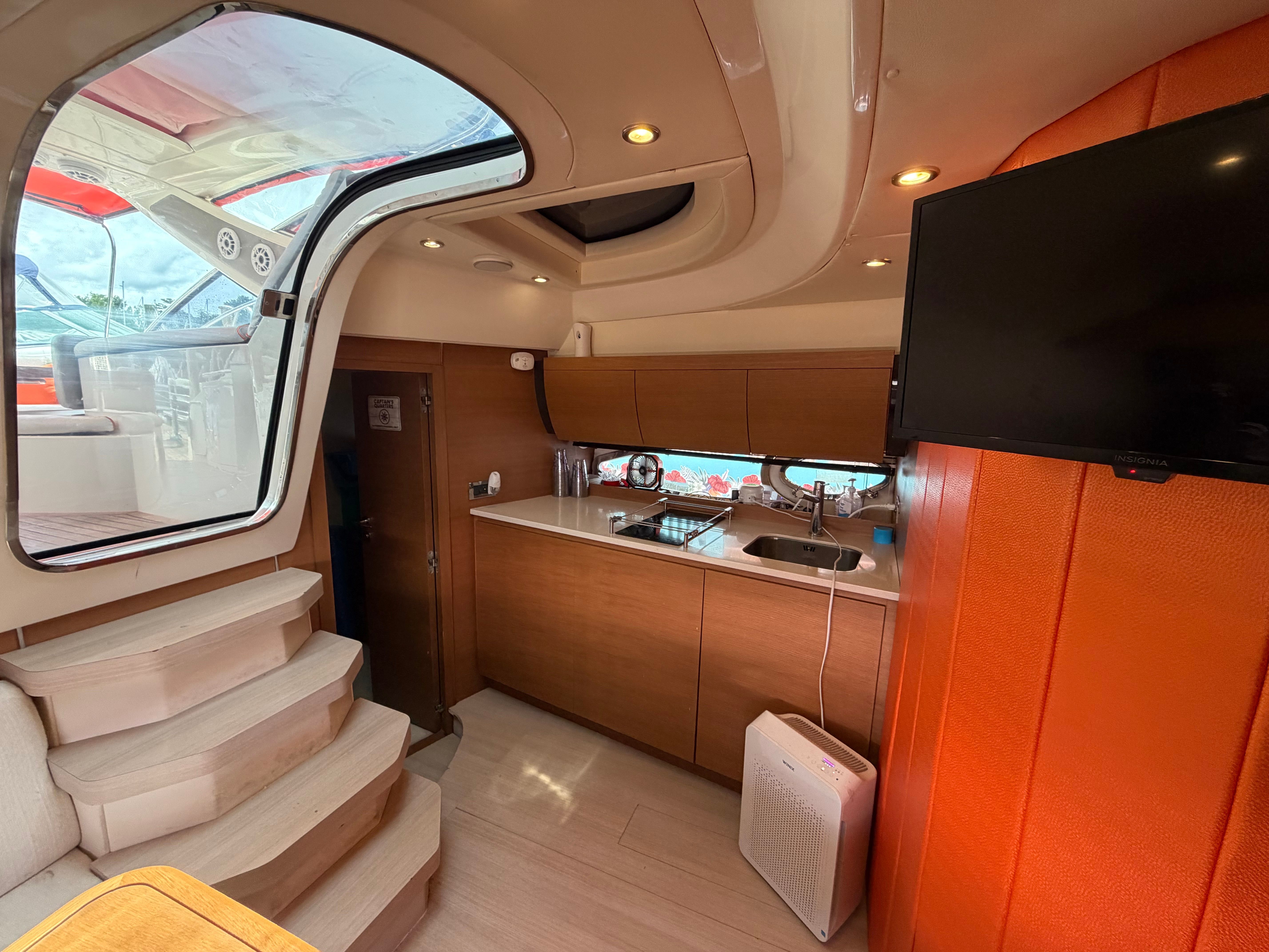Interior of a 2011 Azimut Atlantis 40 with modern kitchen and staircase.
