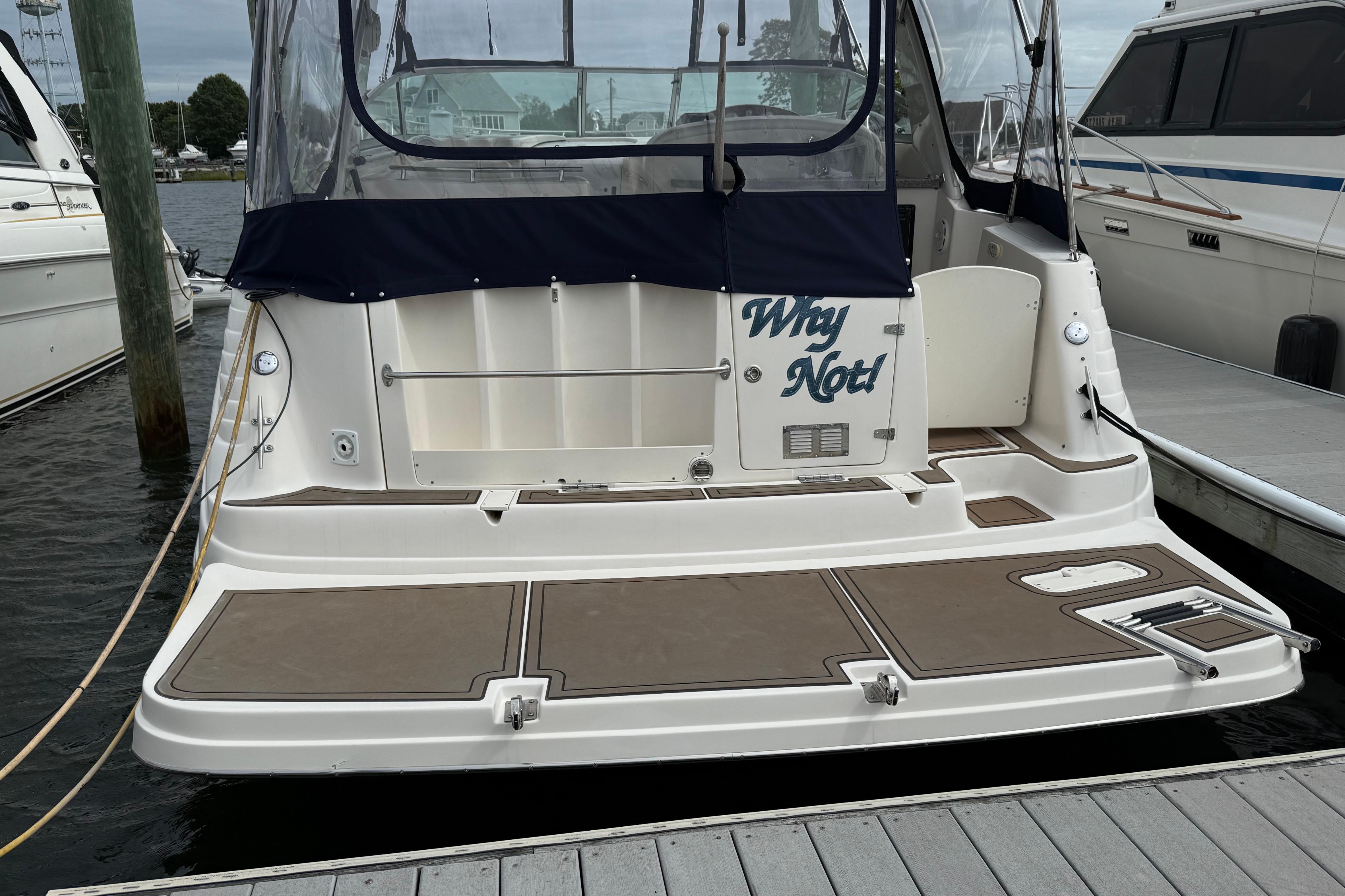 2004 Rinker 342 boat docked, featuring "Why Not!" on the stern.