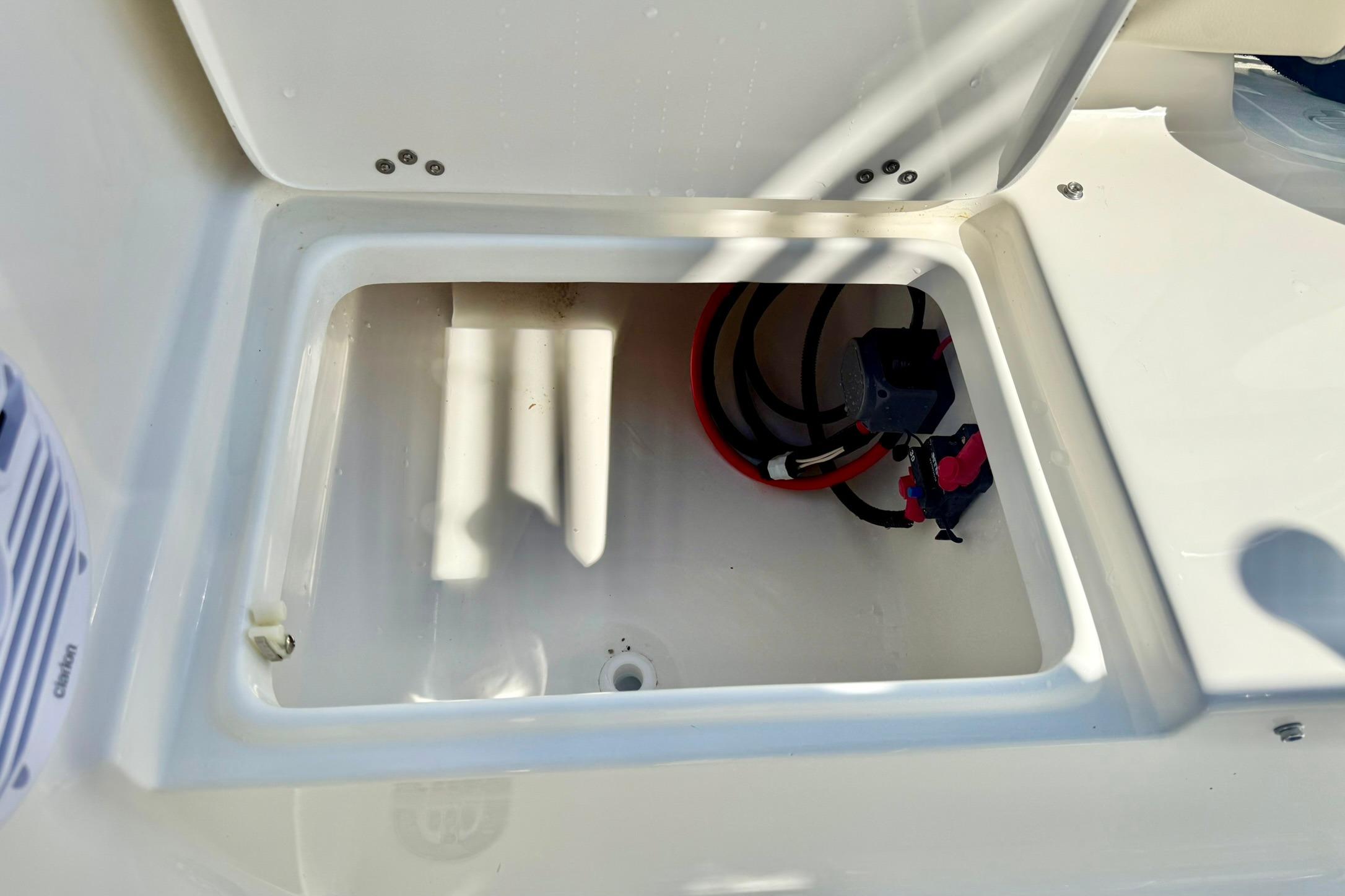 Open storage compartment in 2026 Key West 189 FS boat, showing wiring and connections.